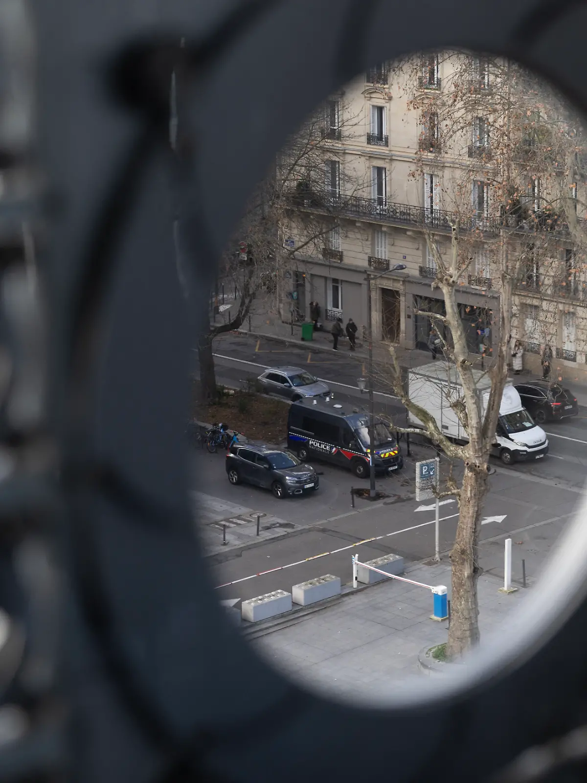 French police officers, seen from the Institut, patrol in front of the Institut du Monde Arabe (IMA - Arab World Institute) during a search as part of investigations entrusted to the National Anti-Fraud Office (ONAF) on the Epstein case linked to its president Jack Lang, at the Institut du Monde Arabe in Paris on February 16, 2026. Former French Culture Minister Jack Lang has offered his resignation from the Arab World Institute (Institut du Monde Arabe de Paris - IMA), which he has chaired since 2013, over Epstein links, according to a letter seen by AFP on February 7, 2026. (Photo by Charlotte SIEMON / AFP)