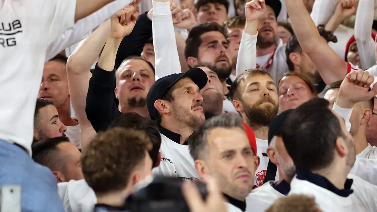 Ein bewegter Julian Schuster umgeben von feiernden Freiburg-Fans.