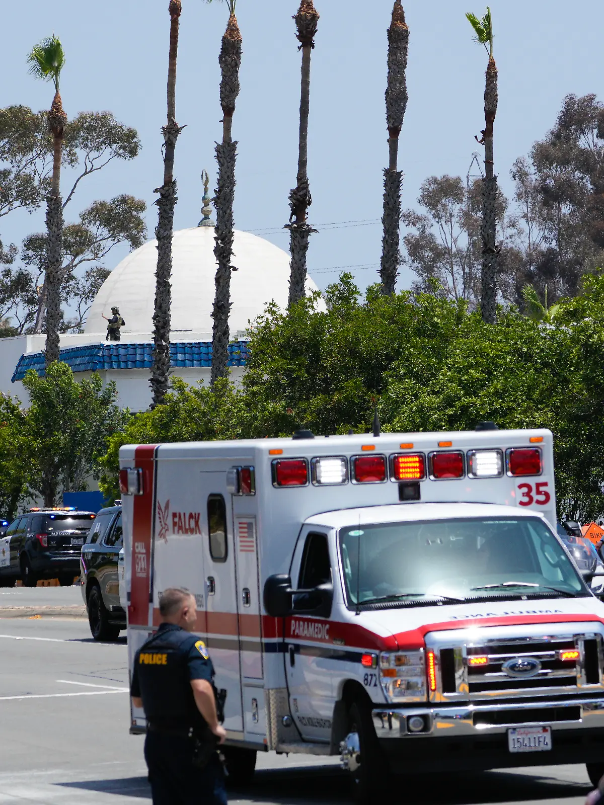 May 18, 2026, San Diego, Ca, United States: San Diego, CA - May 18: On Monday, May 18, 2026 in San Diego, CA., a police officer stands guard on the rooftop of the Islamic Center of San Diego. Five dead, including two teenage suspects, at San Diego mosque shooting. A security guard at the Islamic Center of San Diego was among those killed outside the building on Monday morning, police said. (Credit Image: © Nelvin C. Cepeda/San Diego U-T via ZUMA Press Wire