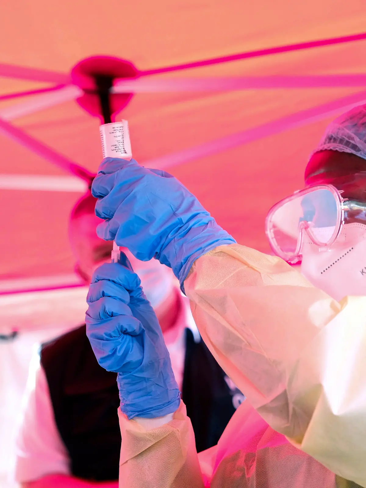 A health worker prepares to administer a vial of a vaccine against the Sudan strain of Ebola, during a trial, at Mulago Referral Hospital, in Kampala, Uganda Monday, Feb. 3, 2025. (AP Photo/Hajarah Nalwadda)