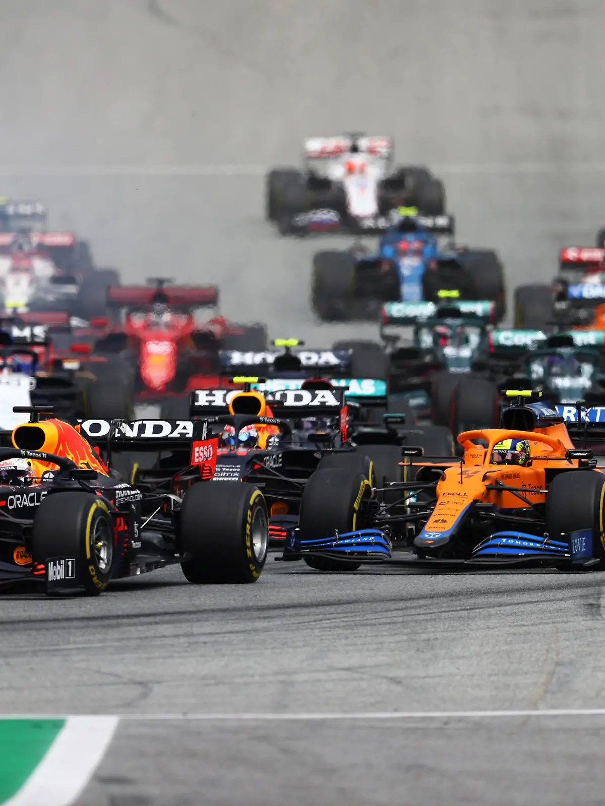 SPIELBERG, AUSTRIA - JULY 04: Max Verstappen of the Netherlands driving the (33) Red Bull Racing RB16B Honda leads the field into turn one at the start during the F1 Grand Prix of Austria at Red Bull Ring on July 04, 2021 in Spielberg, Austria. (Photo by Clive Rose/Getty Images)