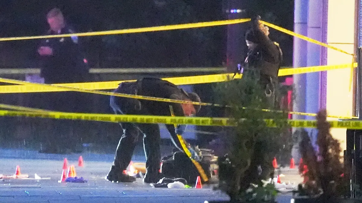 U.S. Secret Service Police examine and photograph evidence at a crime scene near the White House, Saturday, May 23, 2026, in Washington. The U.S. Secret Service shot a person near the White House on Saturday, and a bystander also was shot, a law enforcement official said. (AP Photo/Alex Brandon)