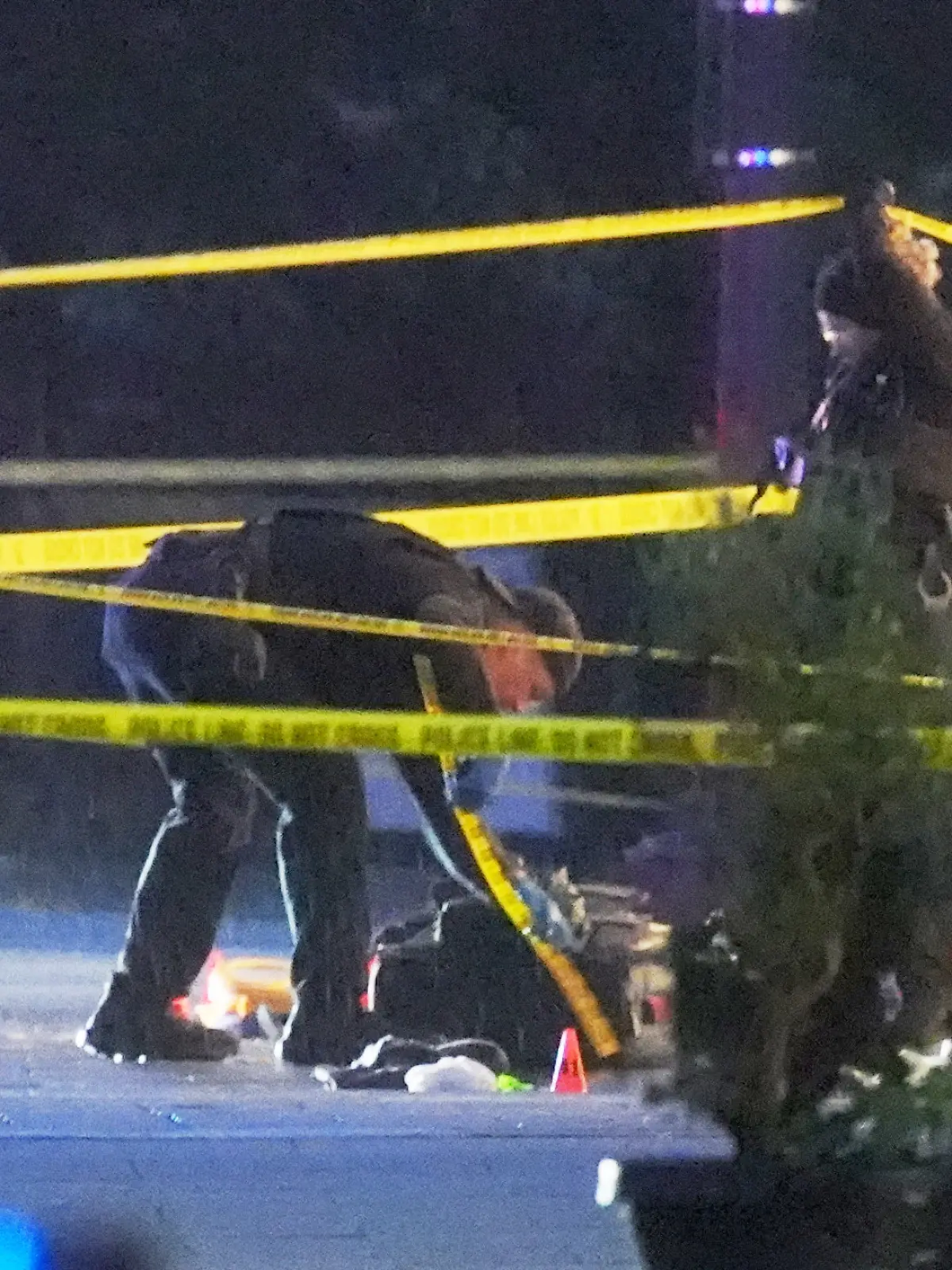 U.S. Secret Service Police examine and photograph evidence at a crime scene near the White House, Saturday, May 23, 2026, in Washington. The U.S. Secret Service shot a person near the White House on Saturday, and a bystander also was shot, a law enforcement official said. (AP Photo/Alex Brandon)