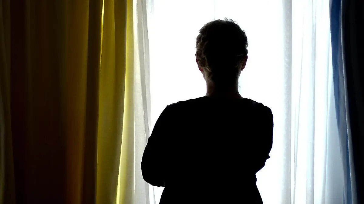 ARCHIV - 28.08.2013, Niedersachsen, ---: Eine junge Frau steht in einem Zimmer eines Frauenhauses. Gewalt gegen Frauen bleibt in Niedersachsen ein gesellschaftliches Dauerproblem. Laut Landeskriminalamt haben diese kriminellen Delikte in den vergangenen Jahren zugenommen. (zu dpa "Gewalt gegen Frauen hält an - Frauenhäuser bieten Hilfen" vom 26.12.2018) Foto: Peter Steffen/dpa +++ dpa-Bildfunk +++