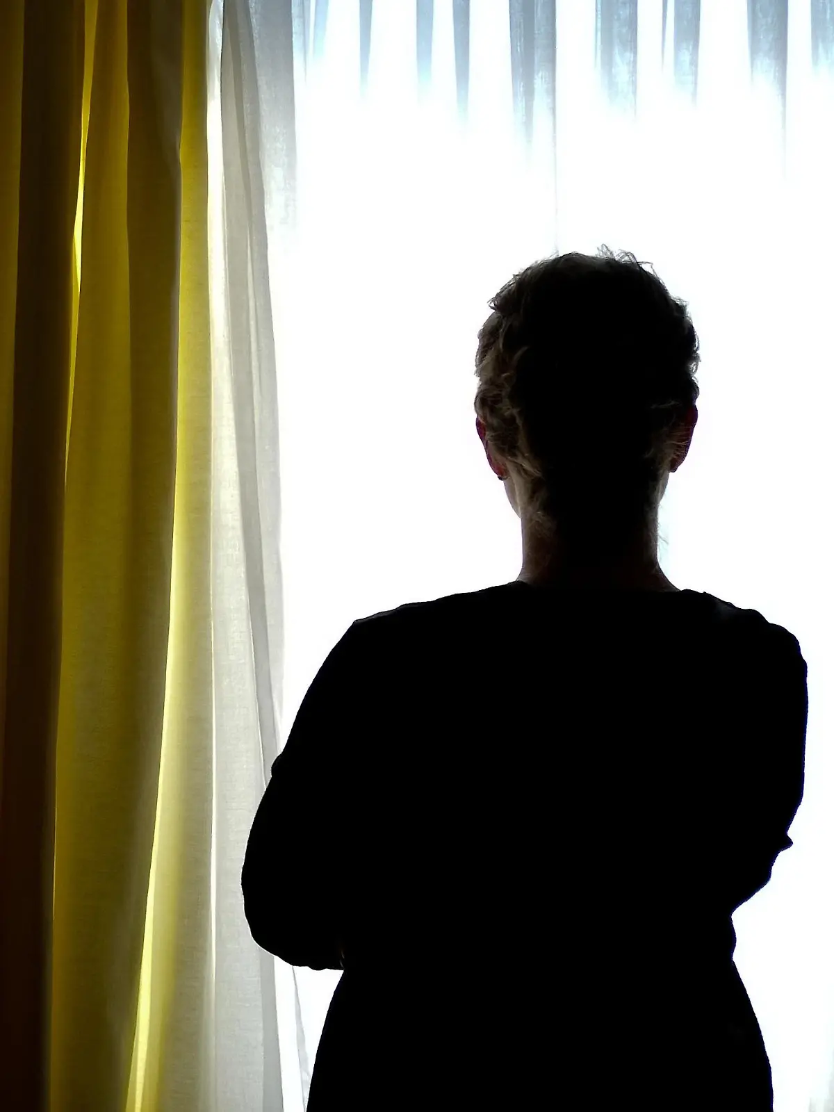 ARCHIV - 28.08.2013, Niedersachsen, ---: Eine junge Frau steht in einem Zimmer eines Frauenhauses. Gewalt gegen Frauen bleibt in Niedersachsen ein gesellschaftliches Dauerproblem. Laut Landeskriminalamt haben diese kriminellen Delikte in den vergangenen Jahren zugenommen. (zu dpa "Gewalt gegen Frauen hält an - Frauenhäuser bieten Hilfen" vom 26.12.2018) Foto: Peter Steffen/dpa +++ dpa-Bildfunk +++