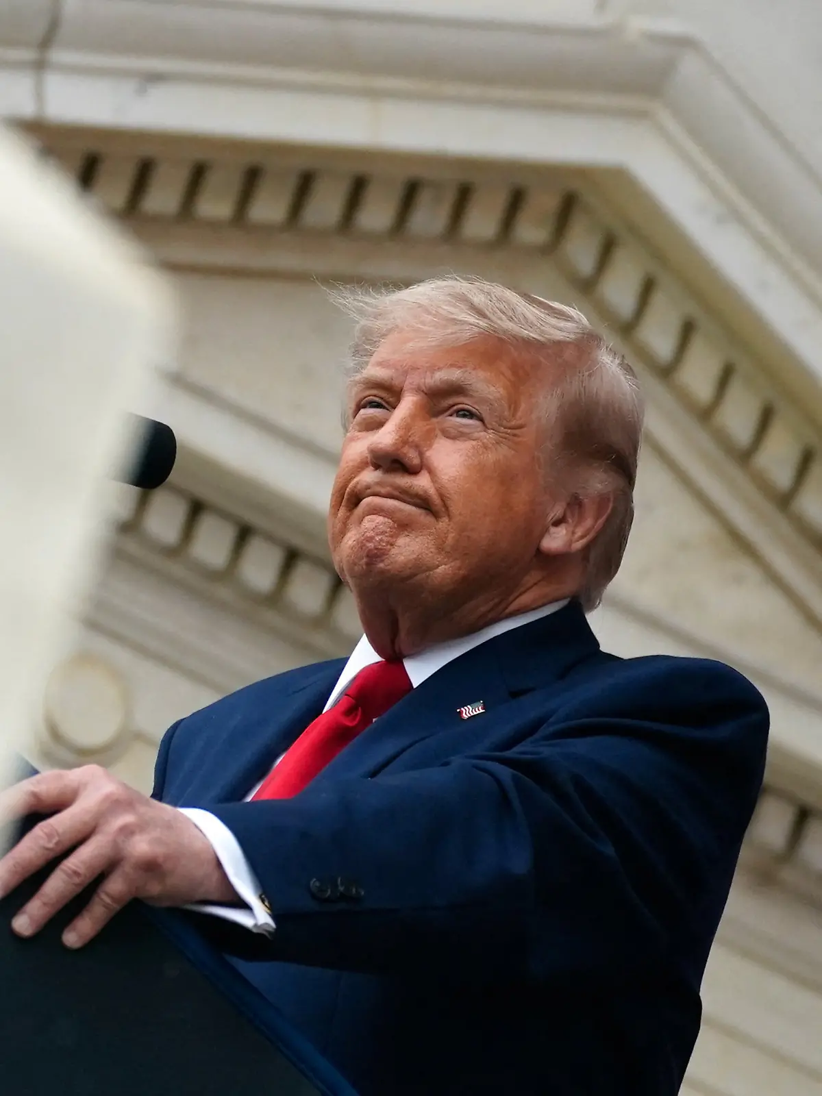 U.S. President Donald Trump looks on as he delivers remarks in the Memorial Amphitheater during a Memorial Day event at Arlington National Cemetery, Arlington, Virginia, U.S., May 25, 2026. REUTERS/Nathan Howard