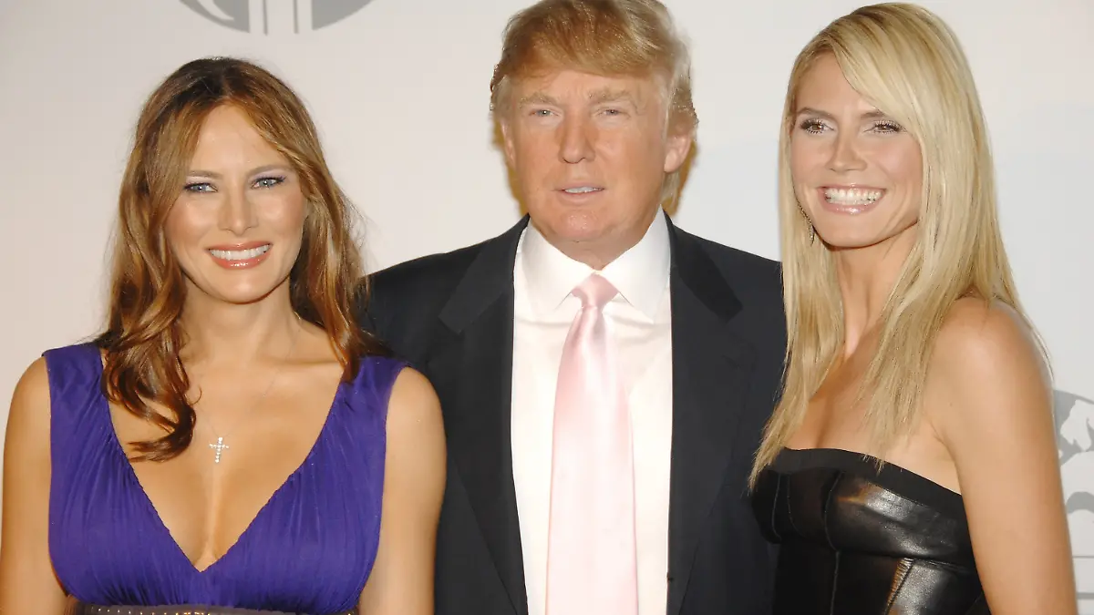 Real estate tycoon Donald Trump, center, poses with model Heidi Klum, right, as his wife Melania at a party to introduce The Trump International Hotel & Tower Dubai, hosted by the real estate development company Nakheel, on Monday, June 23, 2008 in New York. (AP Photo/Evan Agostini)