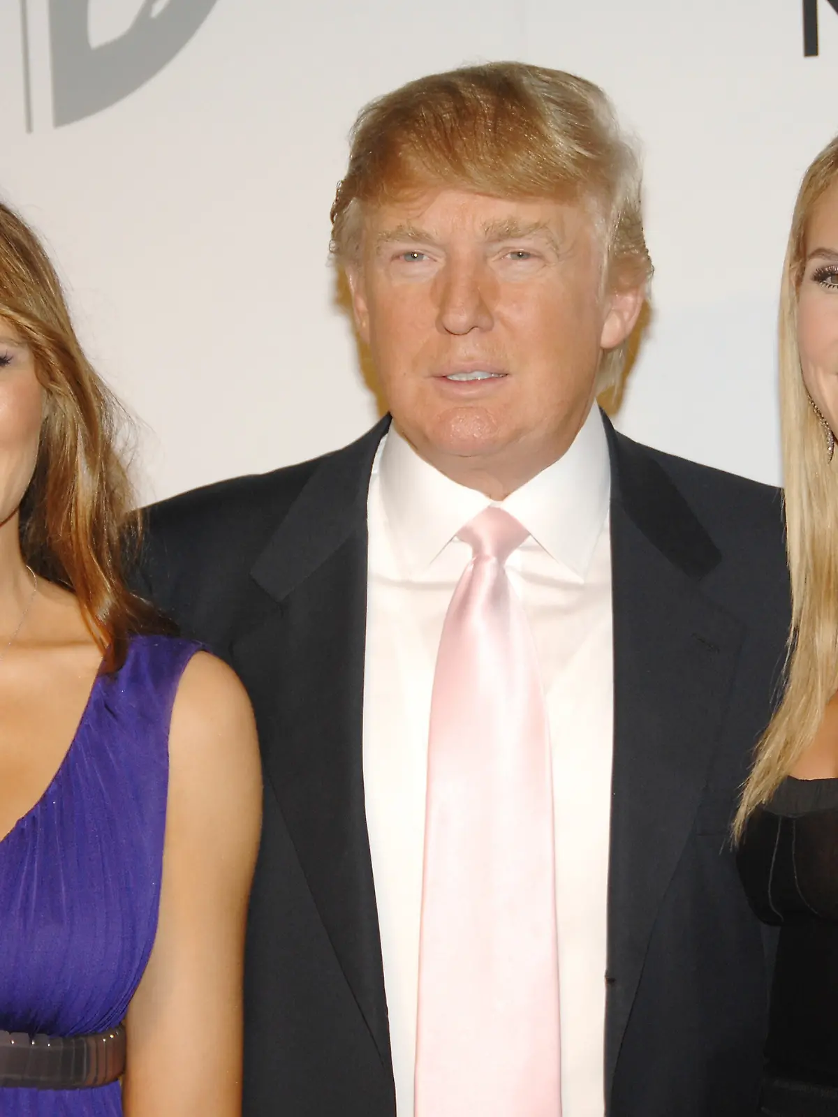 Real estate tycoon Donald Trump, center, poses with model Heidi Klum, right, as his wife Melania at a party to introduce The Trump International Hotel & Tower Dubai, hosted by the real estate development company Nakheel, on Monday, June 23, 2008 in New York. (AP Photo/Evan Agostini)