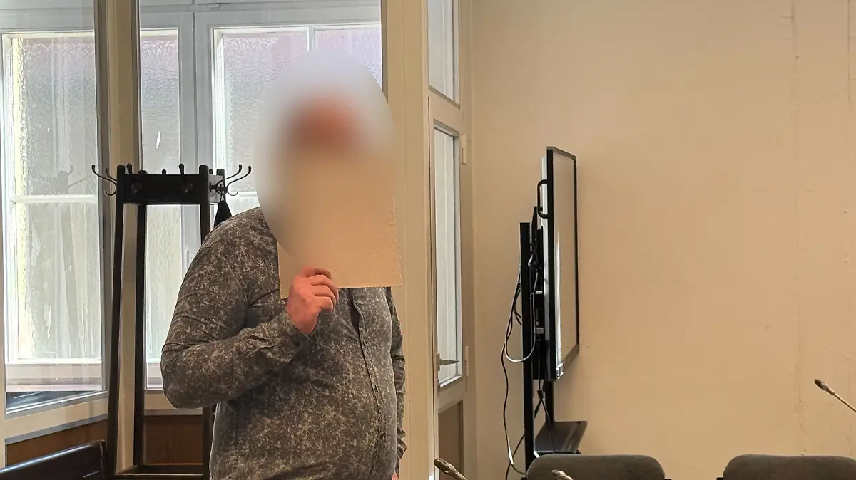 Der Angeklagte blickt in die Kamera. 