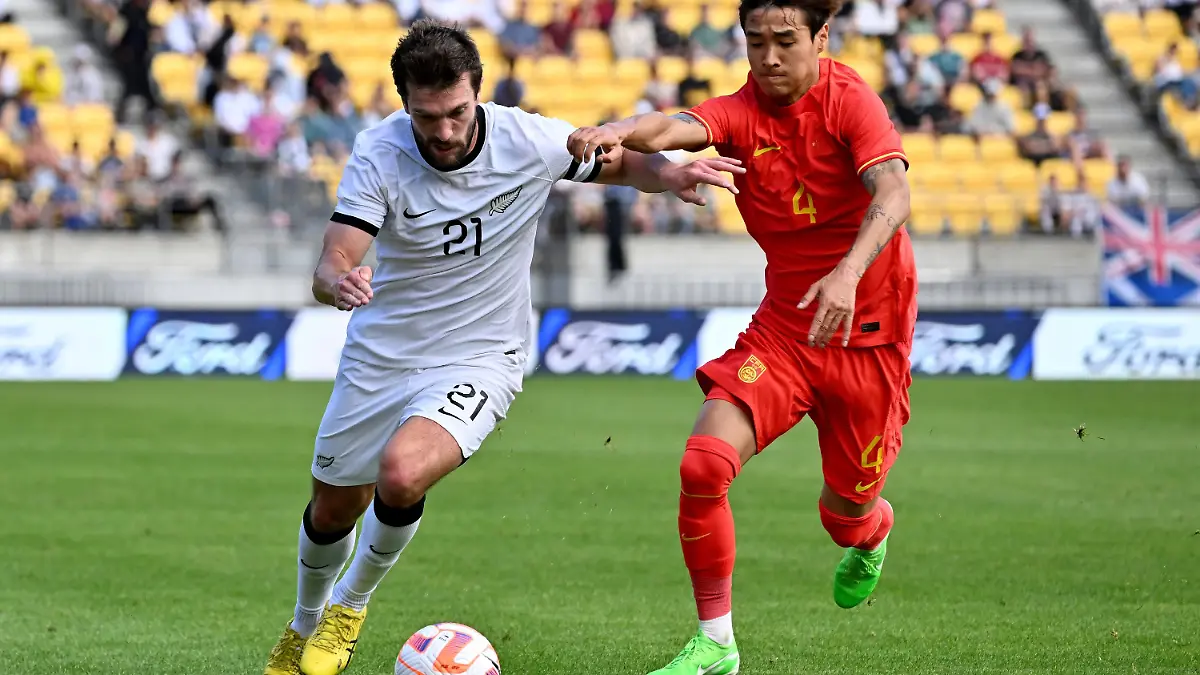 FILE - Tim Payne, left, of the All Whites and Shihao Wei of China compete for the ball during the international soccer friendly between New Zealand and China in Wellington, New Zealand, Sunday, March 26, 2023. (Masanori Udagawa/Photosport via AP,File)