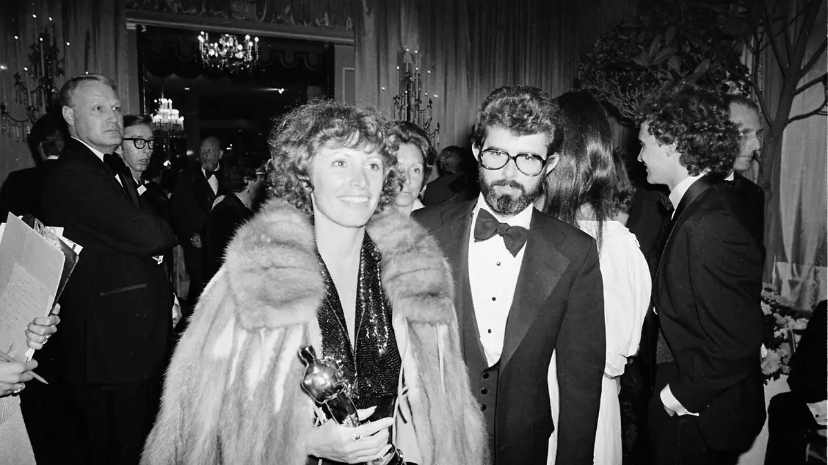 Marcia Lucas, wife of director George Lucas, right, carries her Oscar statuette as they arrive at a post Academy Awards party at the Beverly Hilton Hotel in Los Angeles, Ca., April 4, 1978. She won for best achievement in film editing for "Star Wars," directed by her husband. (AP Photo)