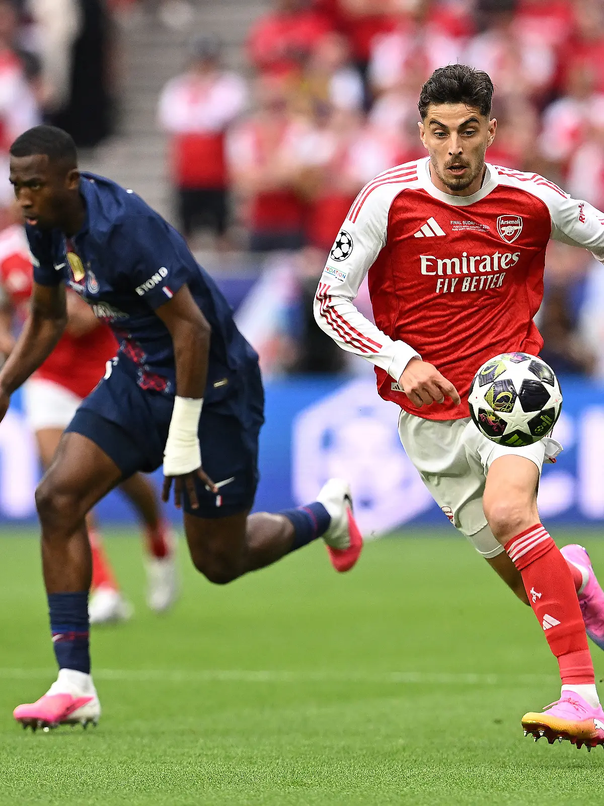 Soccer Football - UEFA Champions League - Final - Paris St Germain v Arsenal - Puskas Arena, Budapest, Hungary - May 30, 2026 Arsenal's Kai Havertz in action with Paris St Germain's Willian Pacho REUTERS/Angelika Warmuth