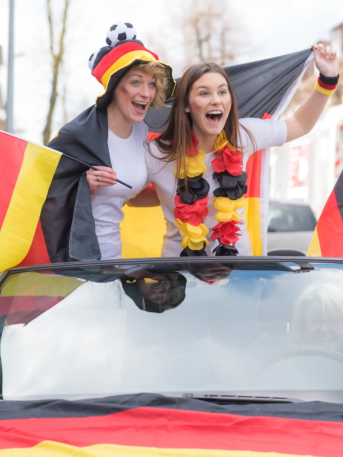 Zwei Frauen feiern den Sieg bei der Fußball-WM im Autokorso.
