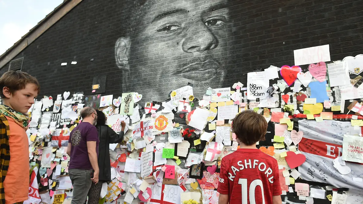 Soccer Football - Stand Up to Racism Demonstration at the Marcus Rashford mural after it was defaced following the Euro 2020 Final between Italy and England - Withington, Manchester, Britain - July 13, 2021 Benjamin Wheeler stands in front of the Marcus Rashford mural after it was defaced following the Euro 2020 Final between Italy and England REUTERS/Peter Powell