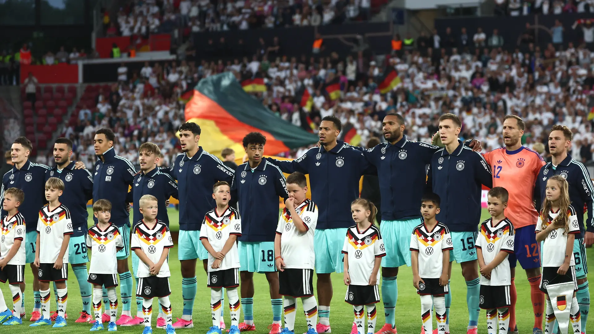 Fußball, Männer: WM-Vorbereitung, Länderspiel vor der WM-Endrunde, Mewa Arena, Die Spieler der deutschen Mannschaft bei der Hymne (l-r), Florian Wirtz, Deniz Undav, Jamal Musiala, Lennart Karl, Aleksandar Pavlović, Nathaniel Brown, Felix Nmecha, Jonathan Tah, Nico Schlotterbeck, Oliver Baumann, Joshua Kimmich.