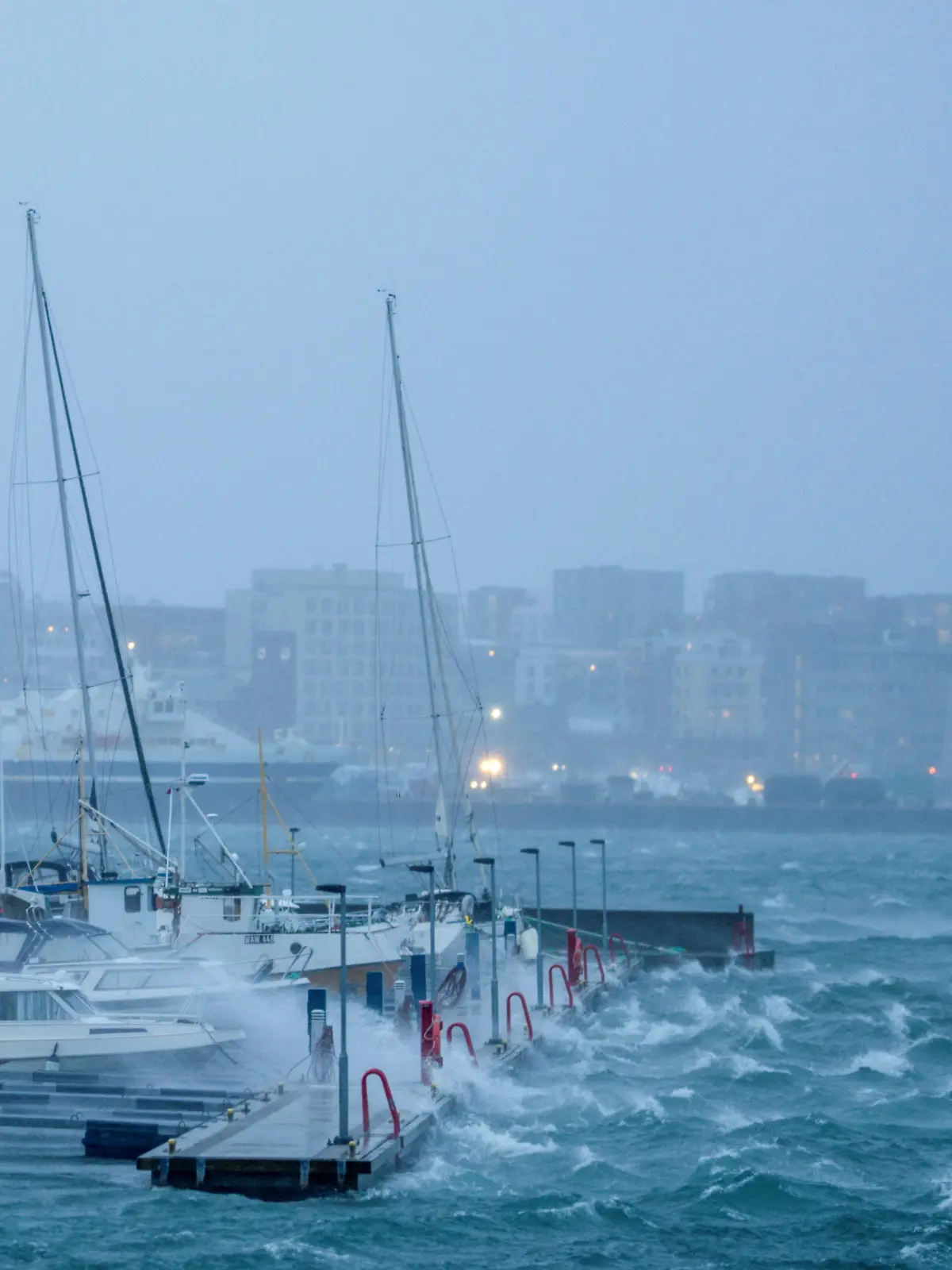 Boats sway in the harbour as waves batter a dock during Storm Ingunn in Bodo, Norway February 1, 2024. NTB/Per-Inge Johnsen via REUTERS   ATTENTION EDITORS - THIS IMAGE WAS PROVIDED BY A THIRD PARTY. NORWAY OUT. NO COMMERCIAL OR EDITORIAL SALES IN NORWAY.