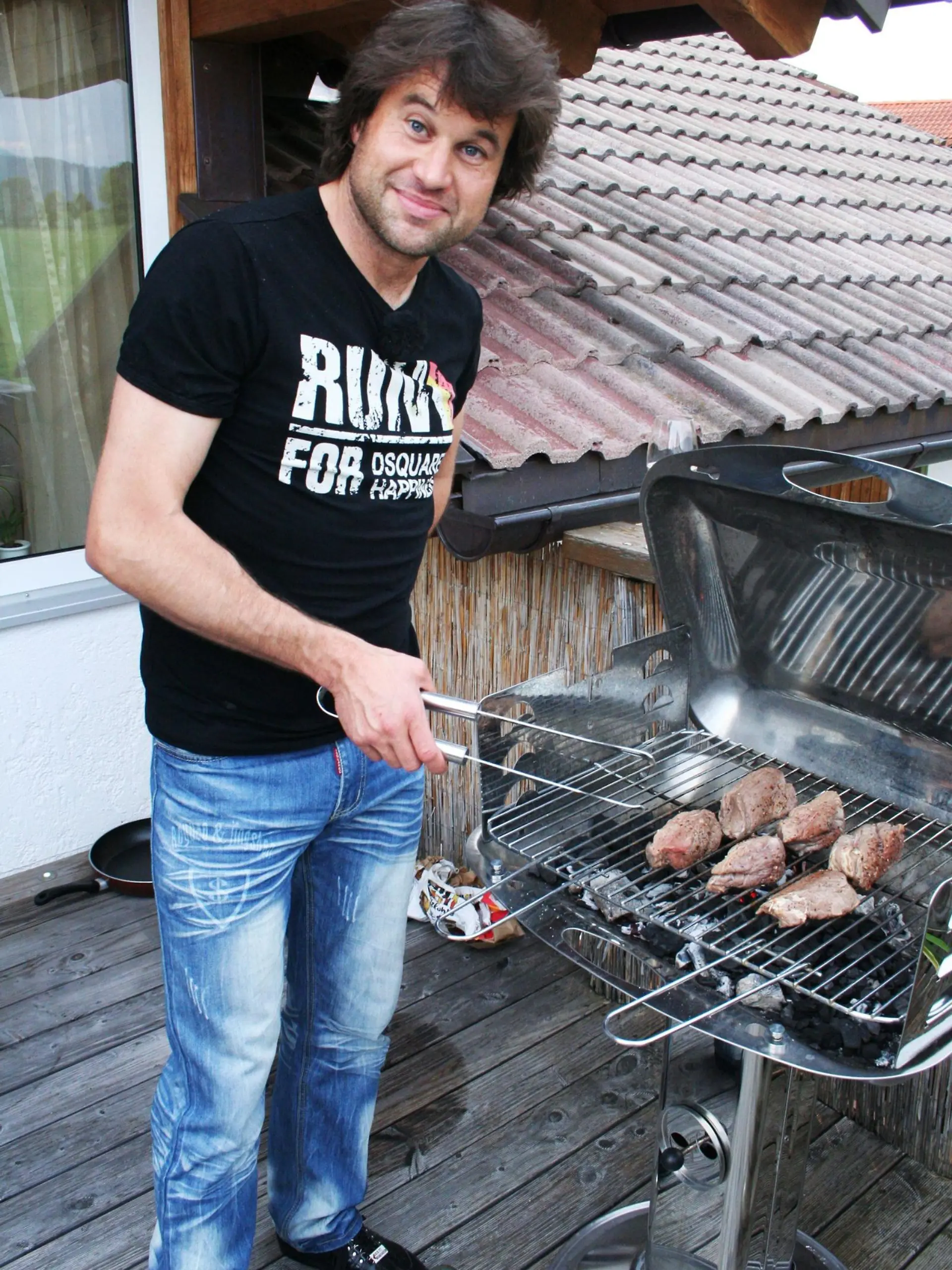 Gastgeber Robert (36) grillt das Steak auf der eigenen Terrasse. Als Hauptspeise gibt es Steak vom Allgäuer Freilandrind mit Bärlauchbutter, dazu Apfel-Zwiebelgemüse mit Weißwein und Karottensalat.