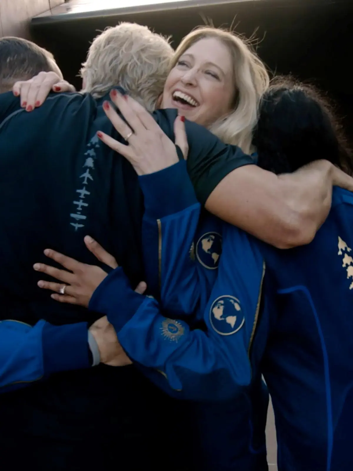 Virgin Galactic's chief astronaut instructor Beth Moses embraces Richard Branson and other crew as he arrives to board the company's passenger rocket plane VSS Unity at Spaceport America near Truth or Consequences, New Mexico, U.S. July 11, 2021 in a still image from video.    Virgin Galactic/Handout via REUTERS.  NO RESALES. NO ARCHIVES. THIS IMAGE HAS BEEN SUPPLIED BY A THIRD PARTY.