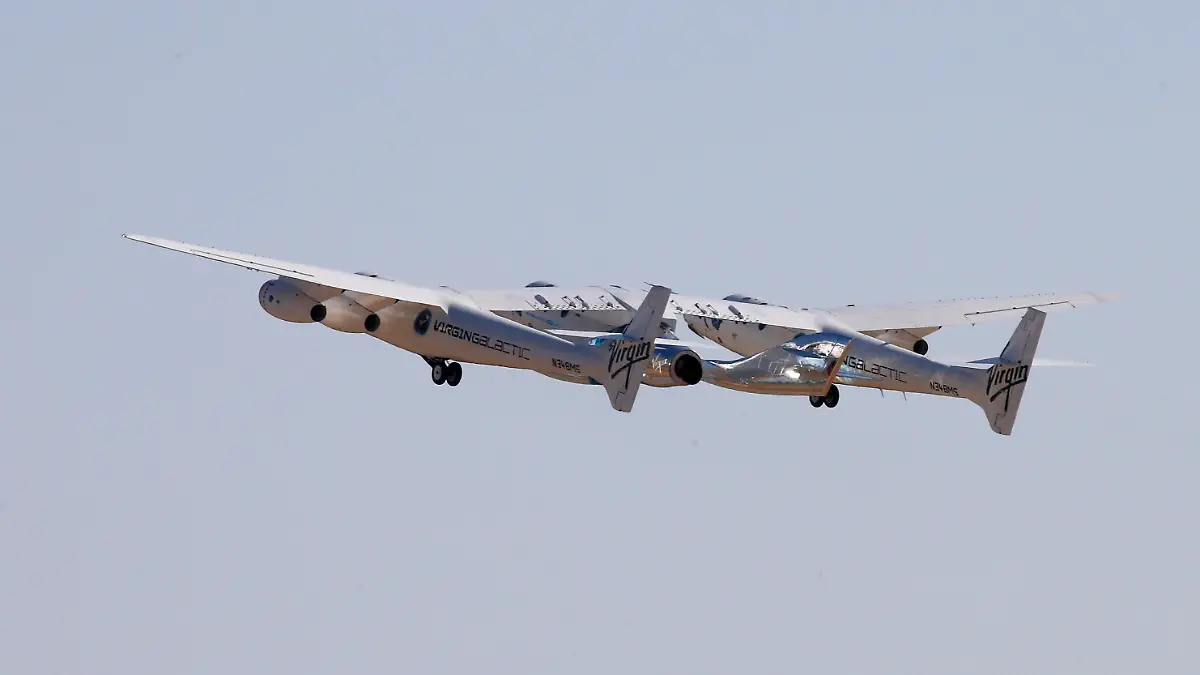 Virgin Galactic's passenger rocket plane VSS Unity, borne by twin-fuselage carrier jet dubbed VMS Eve, takes off with billionaire entrepreneur Richard Branson and his crew for travel to the edge of space at Spaceport America near Truth or Consequences, New Mexico, U.S., July 11, 2021. REUTERS/Joe Skipper