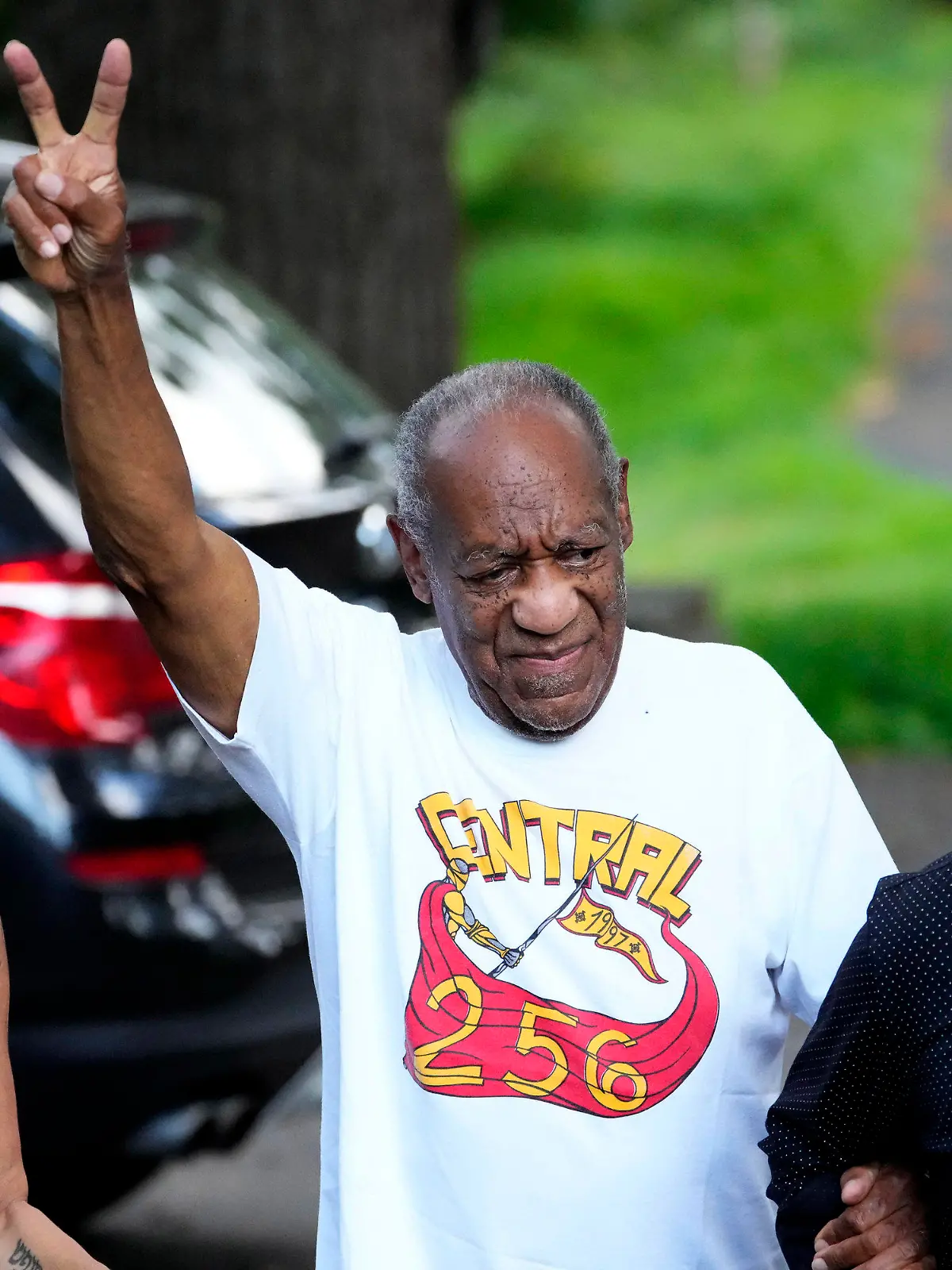 Comedian Bill Cosby, center, and spokesperson Andrew Wyatt, right, approach members of the media gathered outside Cosby's home in Elkins Park, Pa., Wednesday, June 30, 2021, after Pennsylvania's highest court overturned his sex assault conviction. (AP Photo/Matt Slocum)