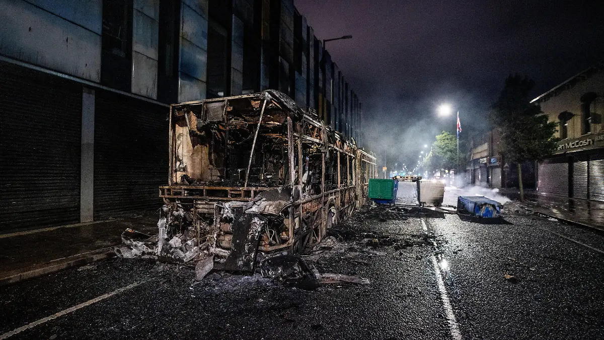 A burnt out bus seen after an anti-immigration protest. Belfast erupted into flames as locals took to the streets to protest against the stabbing of a North Belfast man by a Sudanese national refugee. Road blockades were set up all over Belfast bringing much of the city to a standstill. The protestors are demanding a stop to immigration into Northern Ireland. (Photo by Lab Mo / SOPA Images/Sipa USA)