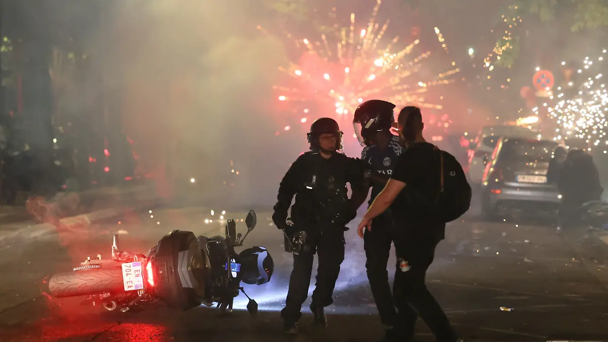 Fußball, Männer: Champions League, Paris Saint-Germain (PSG) - FC Arsenal, Finale, Puskás Aréna, Die Polizei versucht, PSG-Fans zu vertreiben, die in Paris nach dem Champions-League-Finale zwischen Paris Saint-Germain und Arsenal ein Feuerwerk gezündet hatten. Die französische Großstadt Clermont-Ferrand verhängt während der Fußballweltmeisterschaft eine Ausgangssperre für Jugendliche unter 16 Jahren, um Ausschreitungen zu verhindern. (zu dpa: «Bei WM Ausgangssperre für Jugendliche in französischer Stadt») +++ dpa-Bildfunk +++