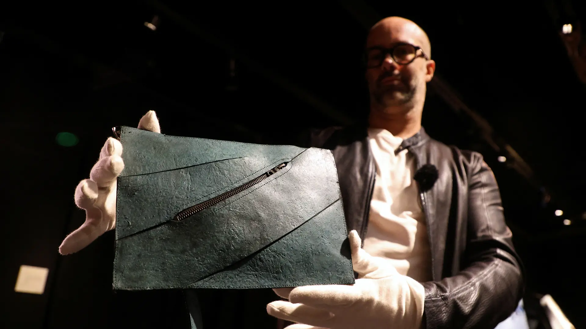Paleontology and natural history expert Iacopo Briano holds a handbag made with collagen derived from Tyrannosaurus rex fossils as it is exhibited at the Drouot auction house ahead of an auction in Paris, France, June 9, 2026. REUTERS/Ardee Napolitano