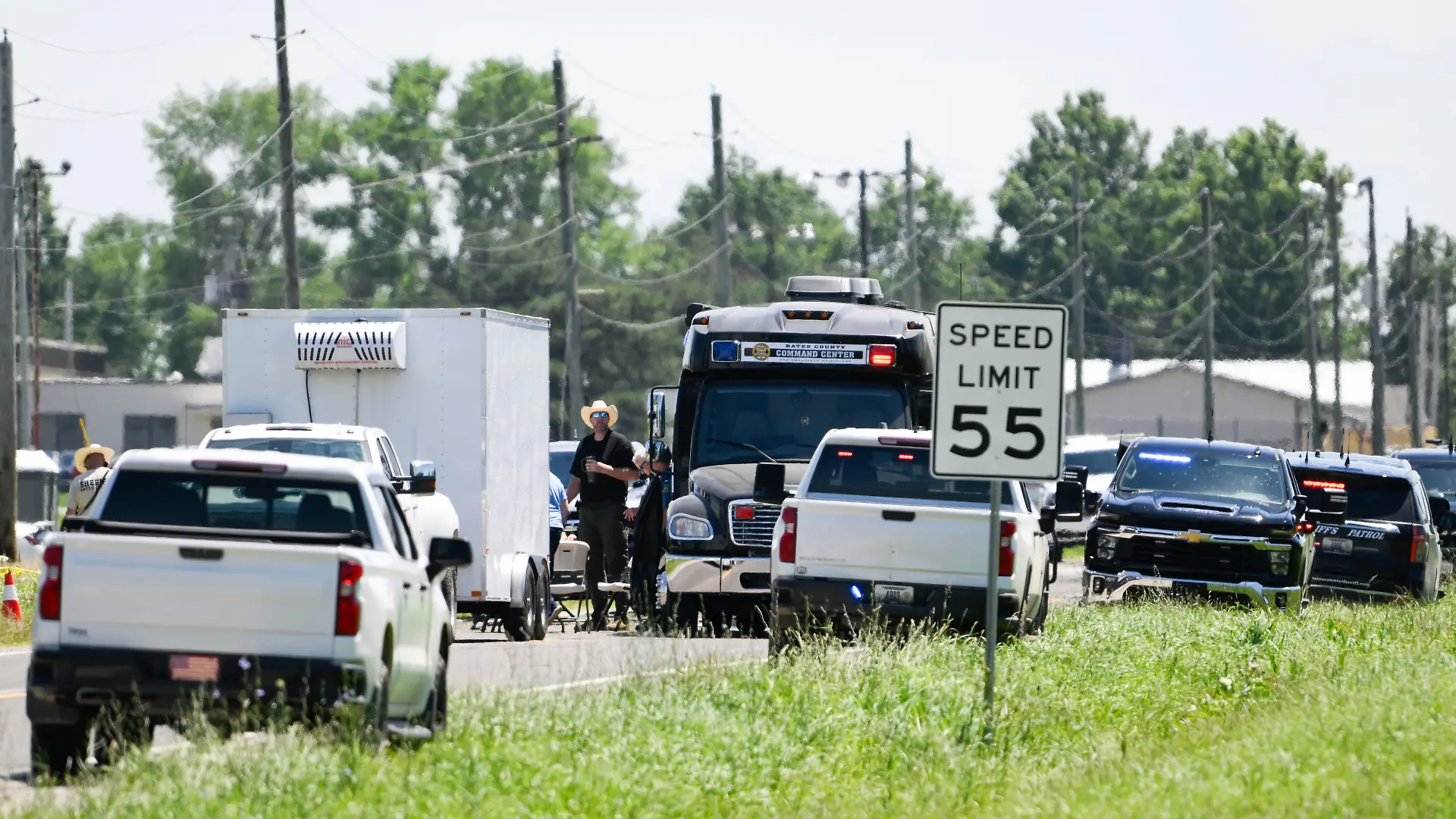 Emergency vehicles parked outside the Butler Memorial Airport after a plane crash in Butler, Mo., Sunday, June 14, 2026. (AP Photo/Reed Hoffmann)