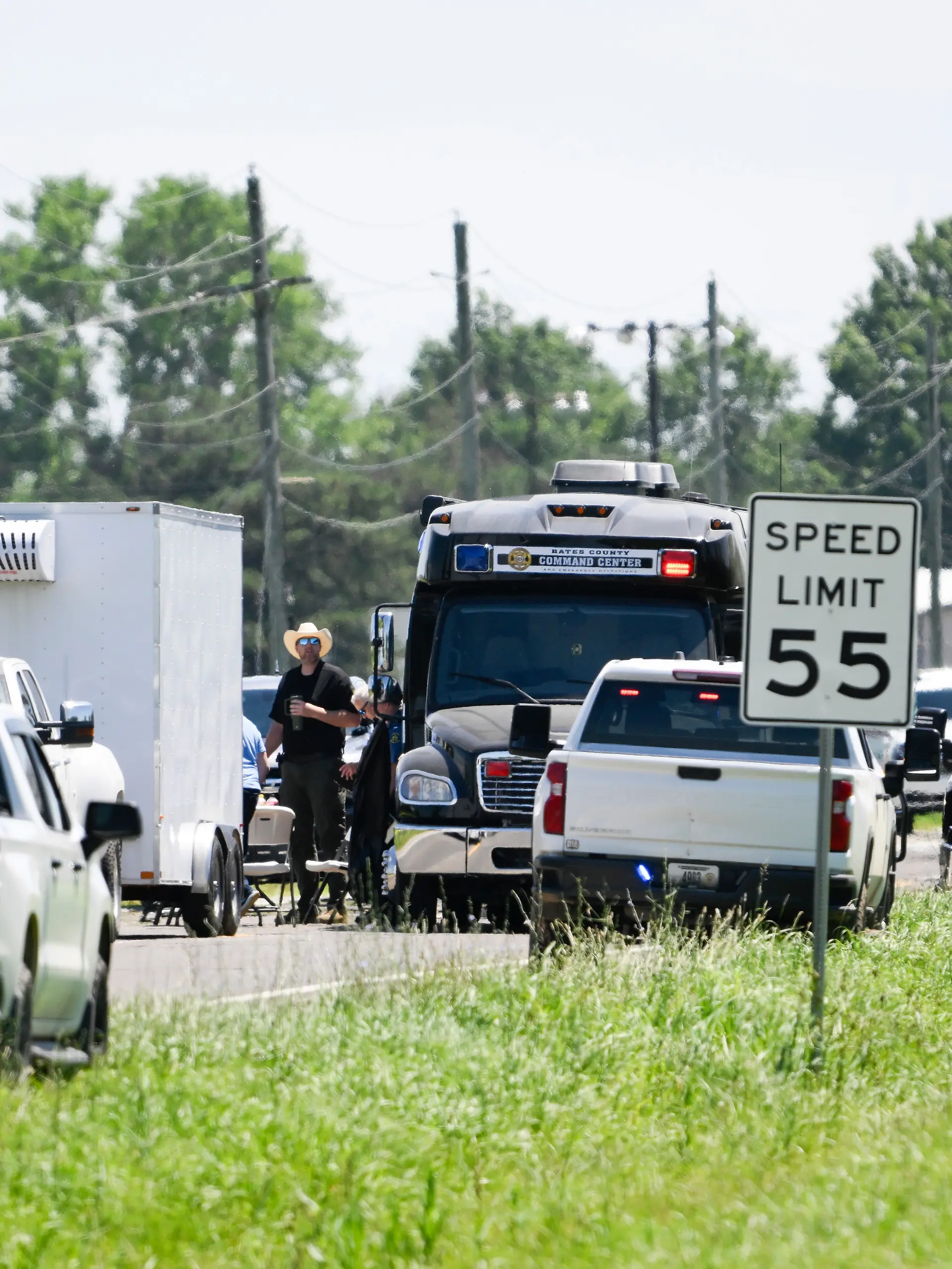 Emergency vehicles parked outside the Butler Memorial Airport after a plane crash in Butler, Mo., Sunday, June 14, 2026. (AP Photo/Reed Hoffmann)
