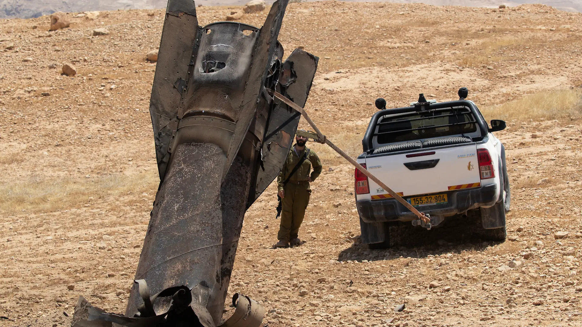 An Israeli soldier watches as they begin to remove an Iranian ballistic missile sticking out from the desert landscape in the area near Jericho, in the West Bank on Monday, June 8, 2026 after it was intercepted by Israel and fell to the desert. Iran fired barrages of missiles and Israel carried out military strikes on both Beirut and Iran. Both Iran and Israel have signaled they would wind down the military escalation that shattered the two month ceasefire. Photo by Jim Hollander/UPI Photo via Newscom picture alliance
