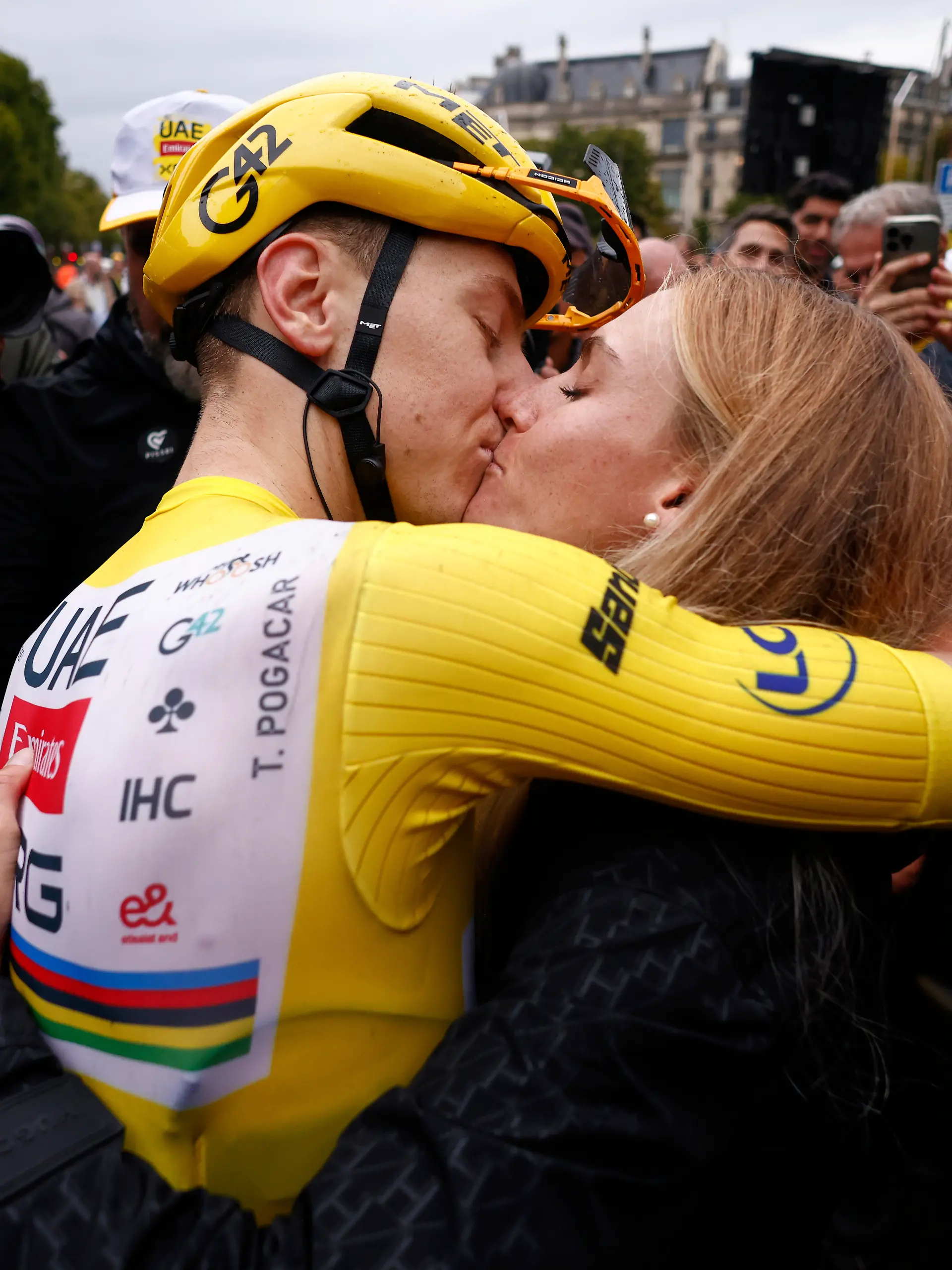 Slovenia's Tadej Pogacar, the Tour de France winner, is greeted by his partner Urska Zigart after finishing, the twenty-first stage of the Tour de France cycling race over 132.3 kilometers (82.1 miles) with start in Mantes-la-Ville and finish on the Champs-Elysees in Paris, France, Sunday, July 27, 2025. (Yoan Valat, Pool Photo via AP)