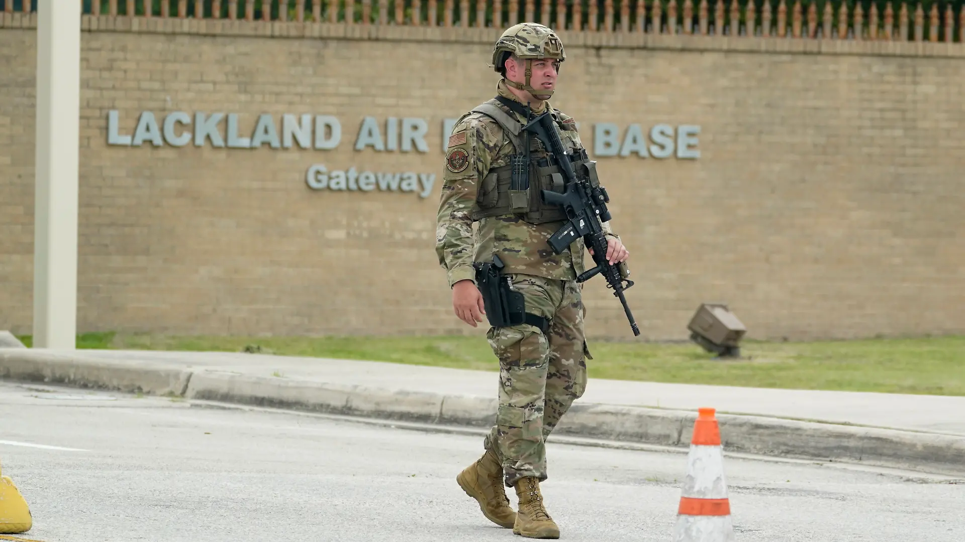 A military policeman stands guard at JBSA-Lackland Air Force Base game, Wednesday, June 9, 2021, in San Antonio. The Air Force was put on lockdown as police and military officials say they searched for two people suspected of shooting into the base from outside. (AP Photo/Eric Gay)