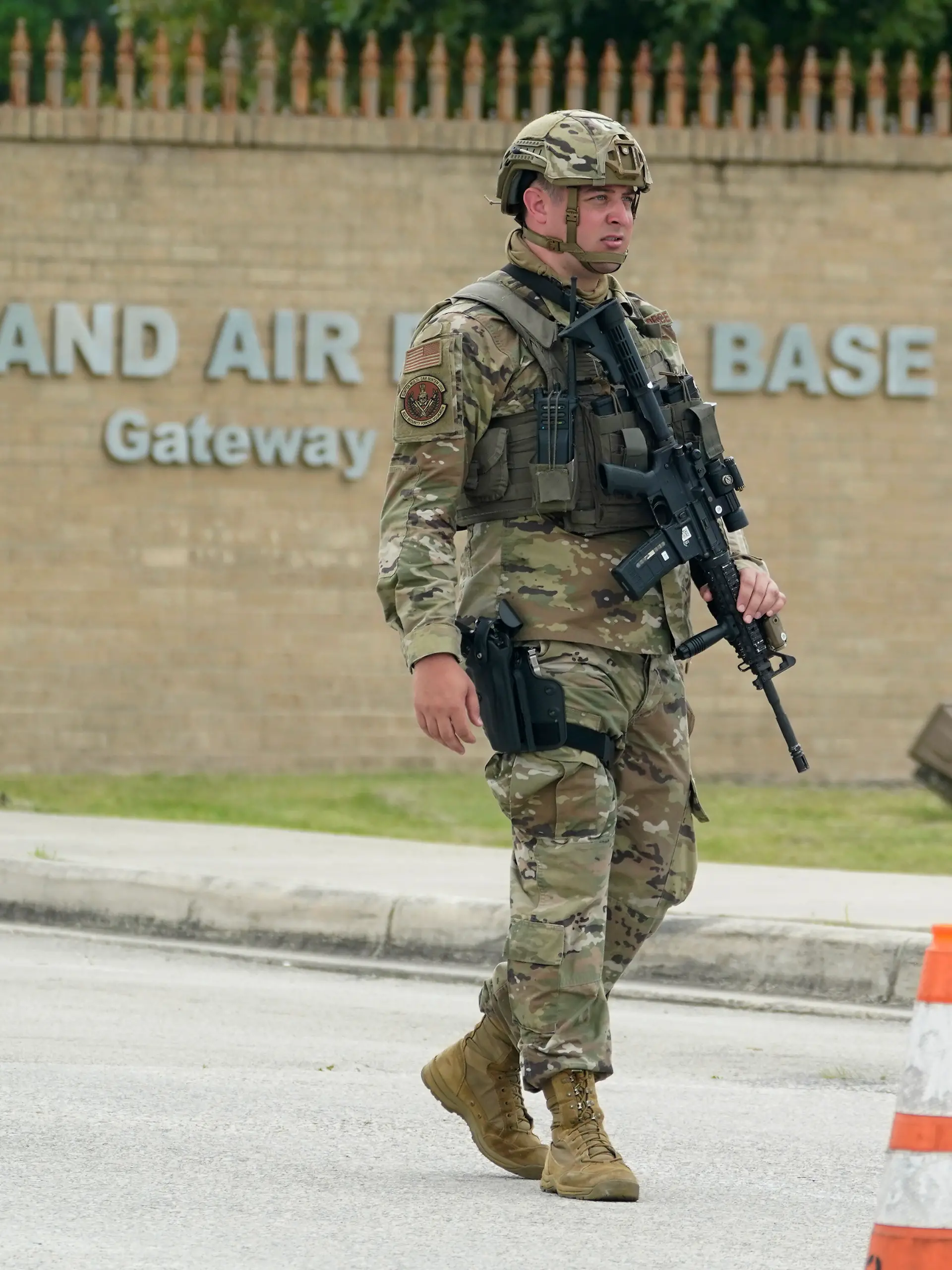 A military policeman stands guard at JBSA-Lackland Air Force Base game, Wednesday, June 9, 2021, in San Antonio. The Air Force was put on lockdown as police and military officials say they searched for two people suspected of shooting into the base from outside. (AP Photo/Eric Gay)
