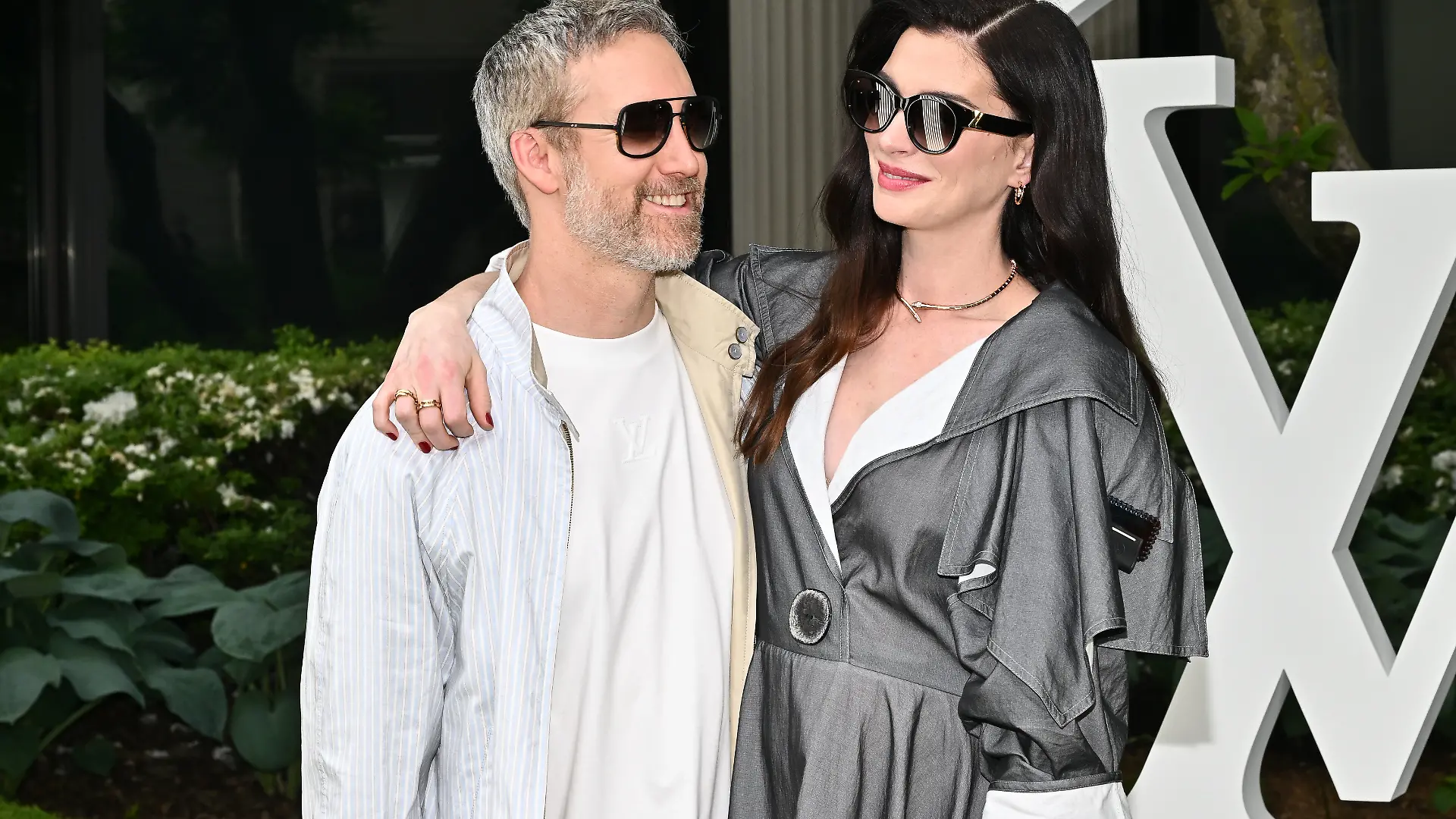 Adam Shulman, left, and Anne Hathaway attend the Louis Vuitton Cruise 2027 Collection fashion show at The Frick Collection on Wednesday, May 20, 2026, in New York. (Photo by Evan Agostini/Invision/AP)