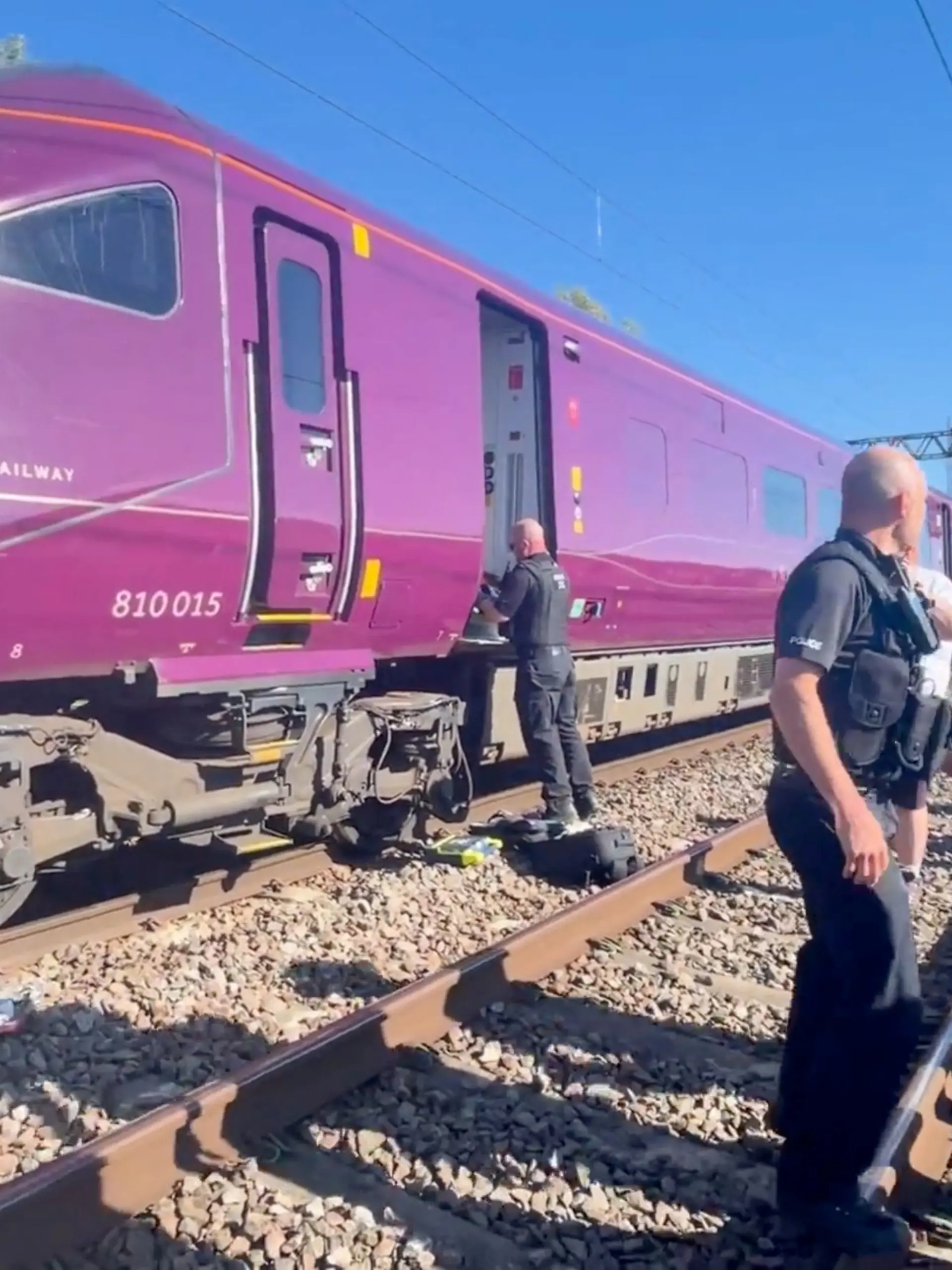 Emergency service workers gather at the scene of a collision involving two trains near Bedford, Britain, June 19, 2026, in this screengrab obtained from a video. Dr Pete Knapp/via REUTERS THIS IMAGE HAS BEEN SUPPLIED BY A THIRD PARTY. MANDATORY CREDIT. NO RESALES. NO ARCHIVES. Verification line: Reuters confirmed the location by the train track, field and vegetation, which matched file and satellite imagery. Date verified by official reports of local authorities.