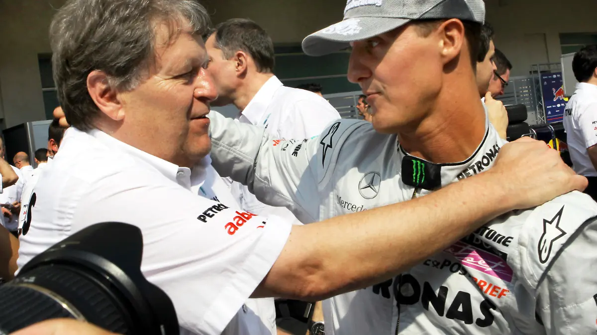 ARCHIV - Mercedes-Motorsportchef Norbert Haug (l) legt Formel-1-Pilot Michael Schumacher am 14.11.2010 die Hand auf die Schulter im Fahrerlager Yas Marina Circuit in den Vereinigten Arabischen Emiraten. Mercedes trennt sich zum Jahresende vom langjährigen Motorsportchef Norbert Haug. Der Vertrag mit dem 60-Jährigen werde im «beiderseitigen Einvernehmen» aufgelöst, hieß es. Foto:Jens Büttner/dpa (zu dpa 0938 vom 13.12.2012) +++(c) dpa - Bildfunk+++