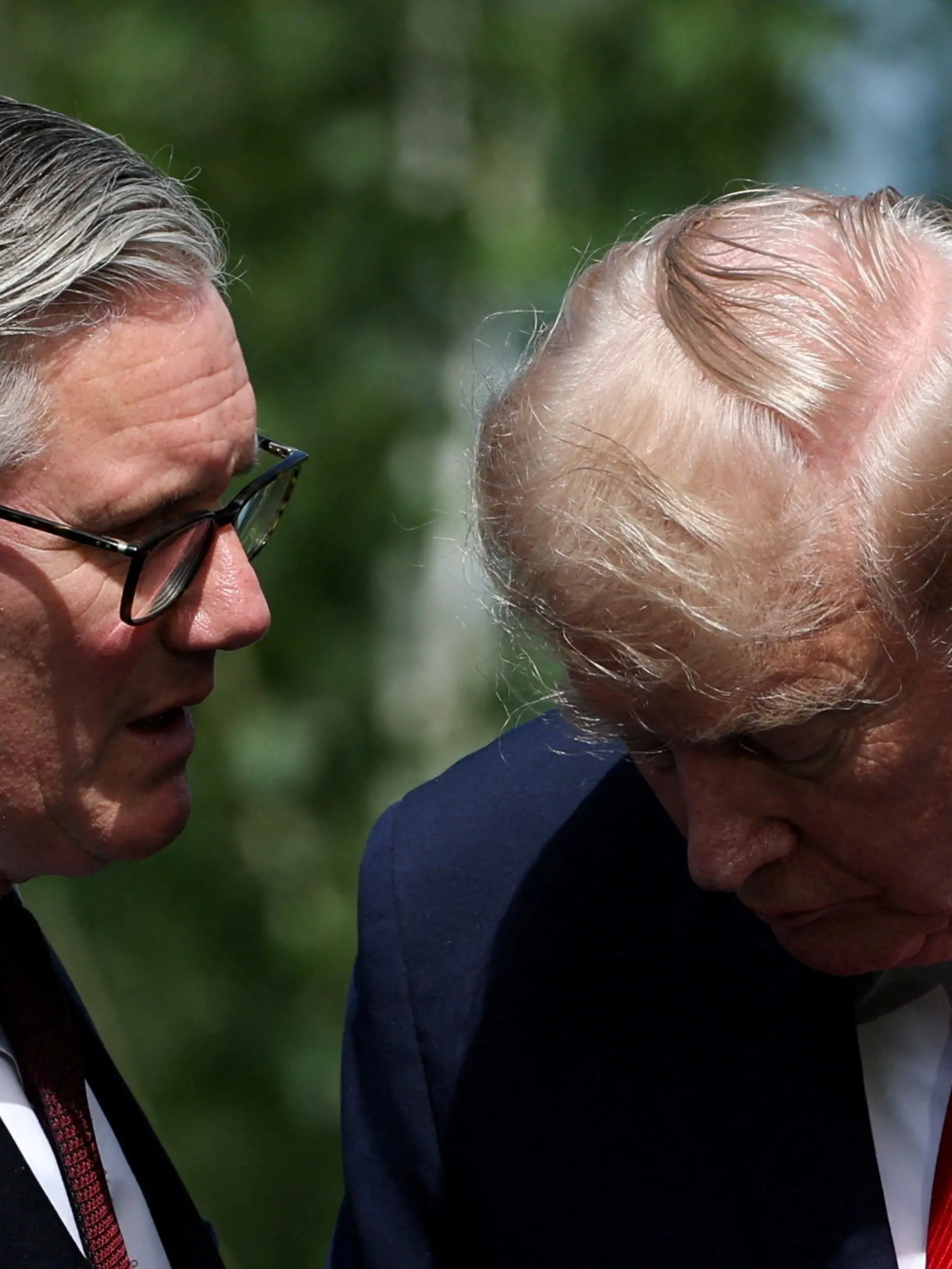 British Prime Minister Keir Starmer and U.S. President Donald Trump speak as they wait for a family photo during the G7 summit, in Evian-les-Bains, France, June 16, 2026. REUTERS/Isabel Infantes/Pool REFILE - FIXING HEADLINE