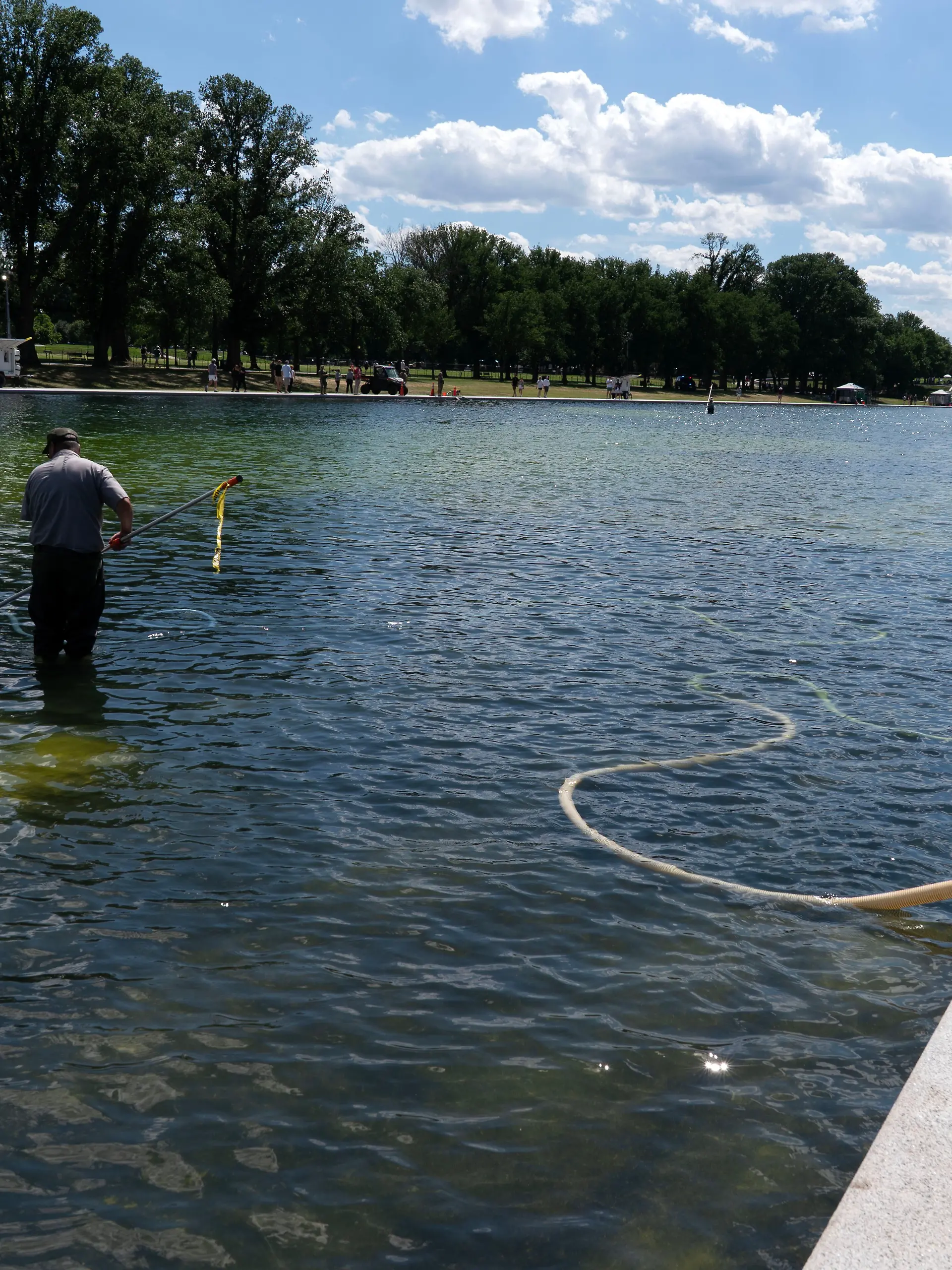 Members of the National Park Service uses a vacuum like device to remove algae from the Lincoln Memorial Reflecting Pool, on the National Mall Friday, June 19, 2026, in Washington. (AP Photo/Jose Luis Magana)