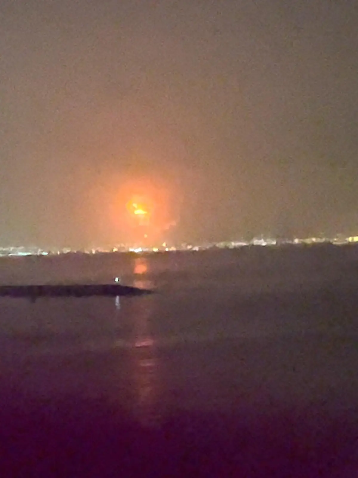 Fire caused by an explosion is seen at Dubai's Jebel Ali Port in Dubai, United Arab Emirates, July 7, 2021, in this still image taken from video obtained from social media. Video taken July 7, 2021. Mandatory credit ALDA FEBRIAN MARPAUNG/via REUTERS ATTENTION EDITORS - THIS IMAGE HAS BEEN SUPPLIED BY A THIRD PARTY. MANDATORY CREDIT. NO RESALES. NO ARCHIVES.