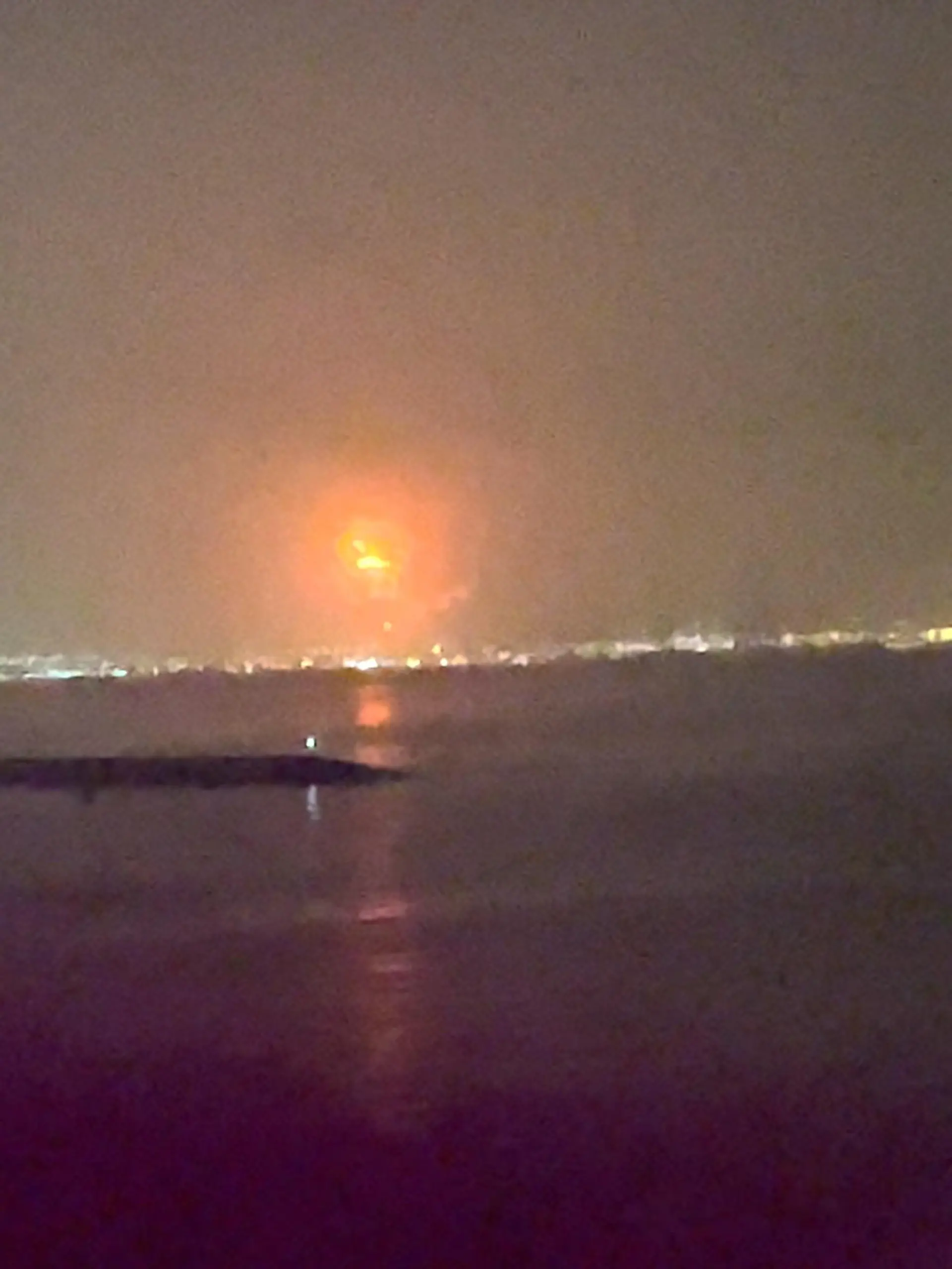 Fire caused by an explosion is seen at Dubai's Jebel Ali Port in Dubai, United Arab Emirates, July 7, 2021, in this still image taken from video obtained from social media. Video taken July 7, 2021. Mandatory credit ALDA FEBRIAN MARPAUNG/via REUTERS ATTENTION EDITORS - THIS IMAGE HAS BEEN SUPPLIED BY A THIRD PARTY. MANDATORY CREDIT. NO RESALES. NO ARCHIVES.