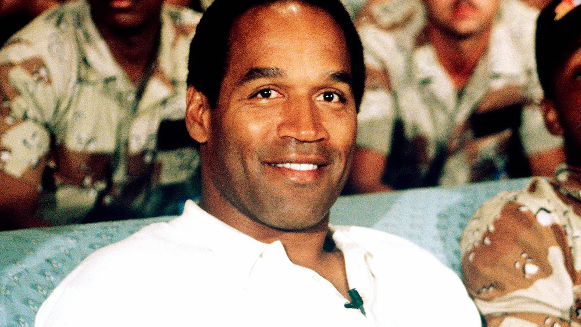 NBC Sports commentator and former professional football player O J Simpson sits with a group of ser