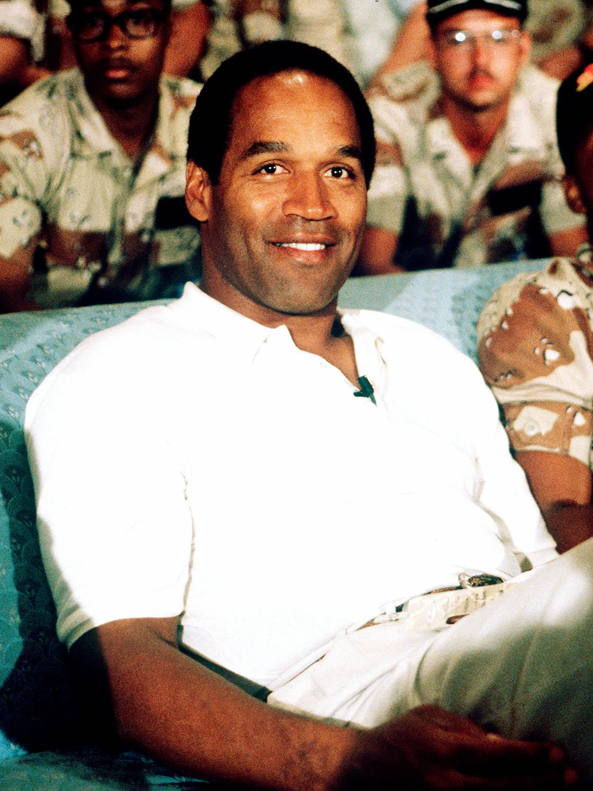 NBC Sports commentator and former professional football player O J Simpson sits with a group of ser