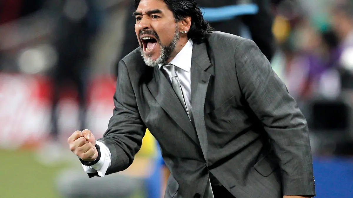 epa02522708 (FILE) A file picture dated 27 June 2010 shows Argentinian national soccer team head coach Diego Armando Maradona celebrating a goal by his team during the FIFA World Cup 2010 Round of 16 soccer match between Argentina and Mexico at the Soccer City stadium outside Johannesburg, South Africa. Maradona saod on 09 January 2011 he will fly to England in February to study an offer from an English Premier League club, Argentine media reported. EPA/KERIM OKTEN Please refer to www.epa.eu/downloads/FIFA-WorldCup2010-Terms-and-Conditions.pdf