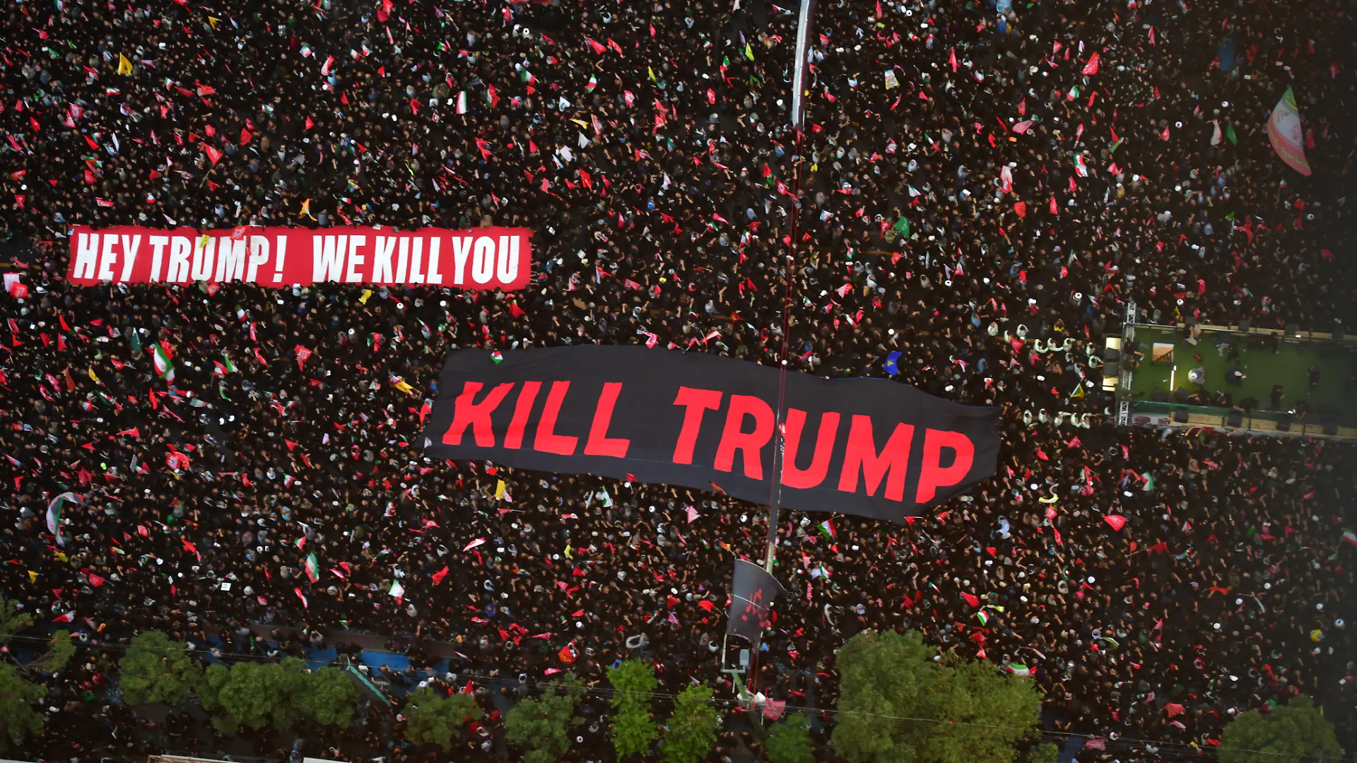 Mashhad, Iran  July 9, 2026: Participants seen holding a banner bearing the English-language message, "We will kill Trump." Thousands of people gather on Imam Reza Boulevard for a final farewell to Ayatollah Khamenei as his coffin is carried toward the Imam Reza Shrine. Many mourners wave red flags, which participants say symbolize a call for revenge against those they hold responsible for his death, alongside other religious flags associated with the Shia community. The procession draws large crowds lining the route leading to the shrine.//FARNOOD_sipa.12870/Credit:Heidari/SIPA/2607101650