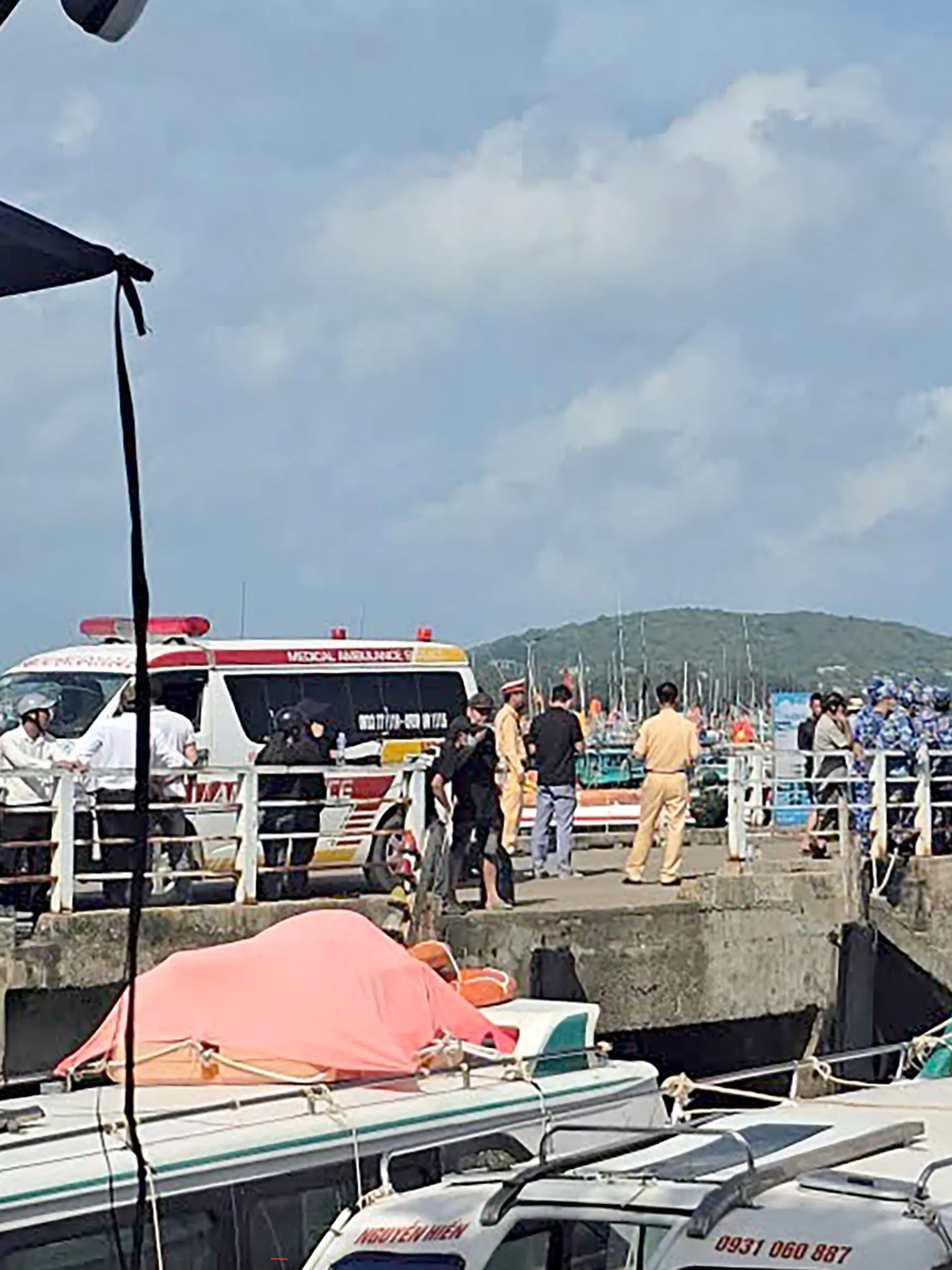 Ambulances line up on a pier to help victims of a boating accident after a tourist vessel capsized off Phu Quoc Island in southern Vietnam's An Giang Province on July 11, 2026. At least 15 people were killed when a tourist boat capsized off an island in Vietnam's south, state media reported on July 11. (Photo by AFP)