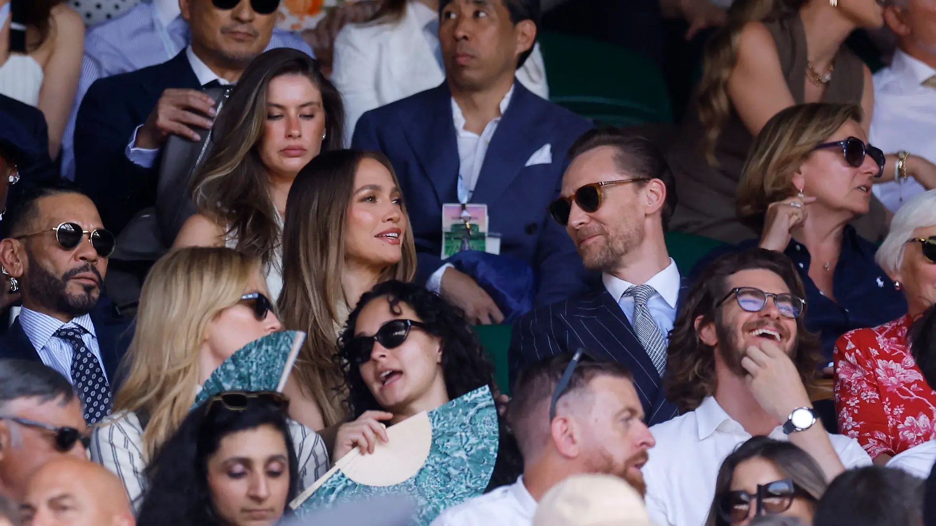 Tennis - Wimbledon - All England Lawn Tennis and Croquet Club, London, Britain - July 12, 2026 Singer Jennifer Lopez and actors Tom Hiddleston and Andrew Garfield in the stands during the final match between Italy's Jannik Sinner and Germany's Alexander Zverev REUTERS/Andrew Couldridge