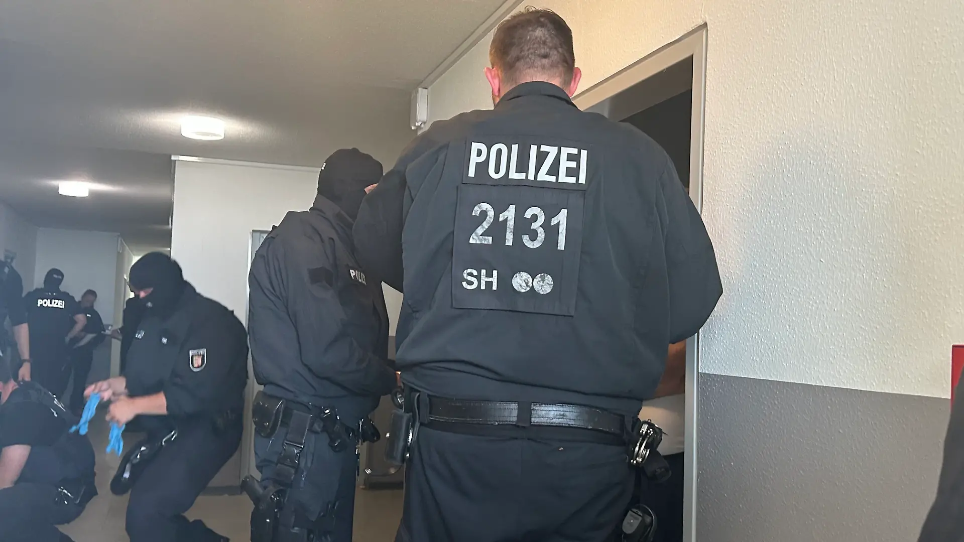 Ein Großaufgebot der Polizei – im unteren dreistelligen Bereich – ist in dem Hochhaus im Kieler Brennpunktviertel Mettenhof im Einsatz.