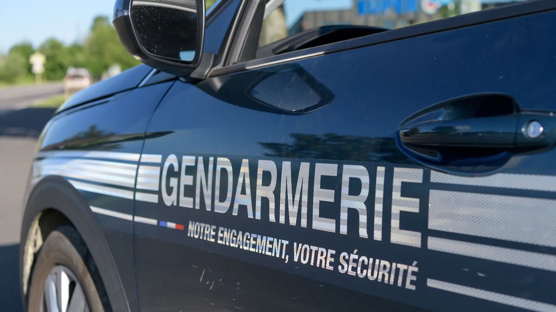 A French gendarme conducts a roadside traffic stop, checking a driver's documents and administering a breath alcohol test during a road safety operation. The control focuses on preventing drunk driving, enforcing traffic regulations, and ensuring compliance with vehicle documentation requirements. France.//BIAUCHRISTINE_sipa.11184/Credit:Christine BIAU/SIPA/2607061334