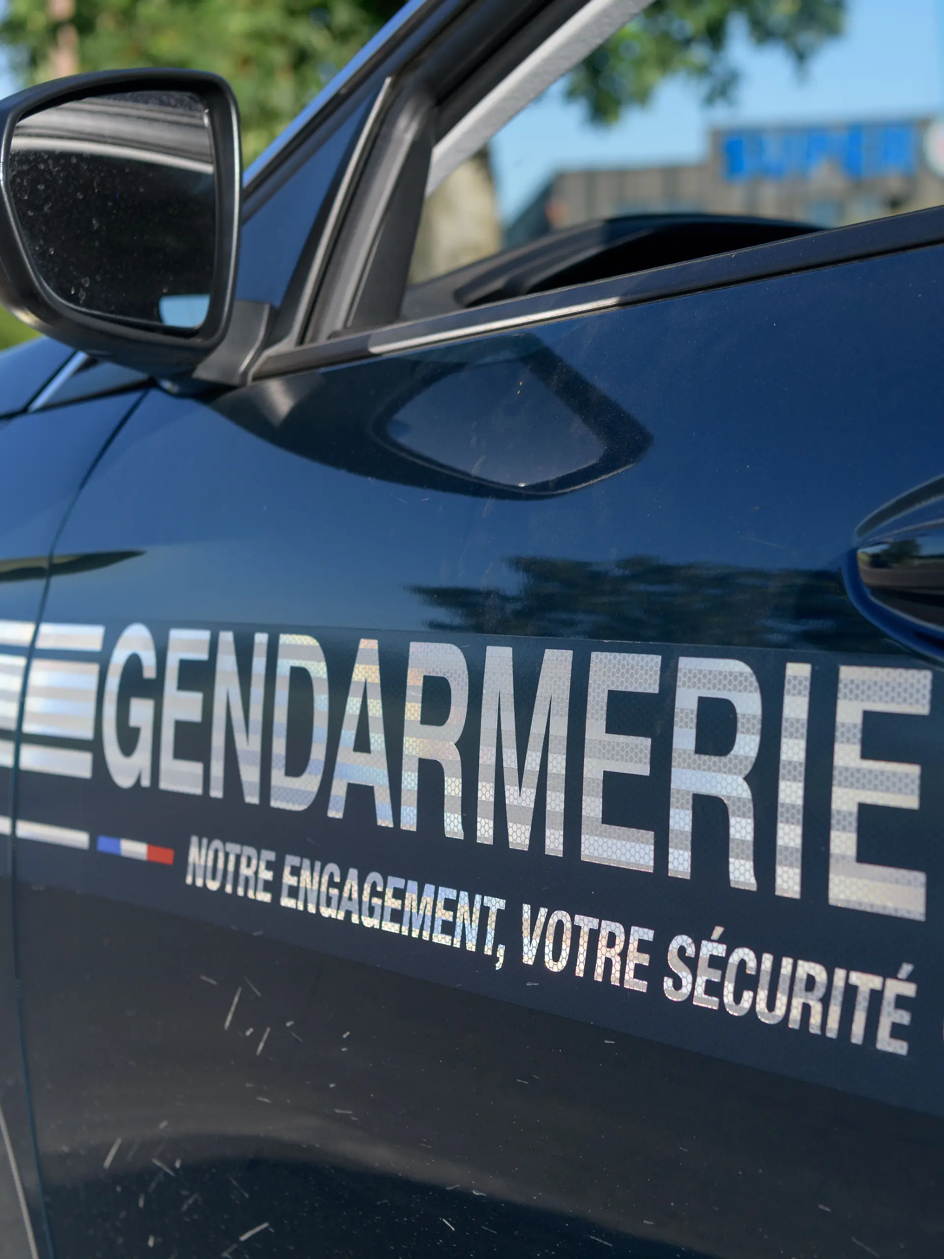 A French gendarme conducts a roadside traffic stop, checking a driver's documents and administering a breath alcohol test during a road safety operation. The control focuses on preventing drunk driving, enforcing traffic regulations, and ensuring compliance with vehicle documentation requirements. France.//BIAUCHRISTINE_sipa.11184/Credit:Christine BIAU/SIPA/2607061334
