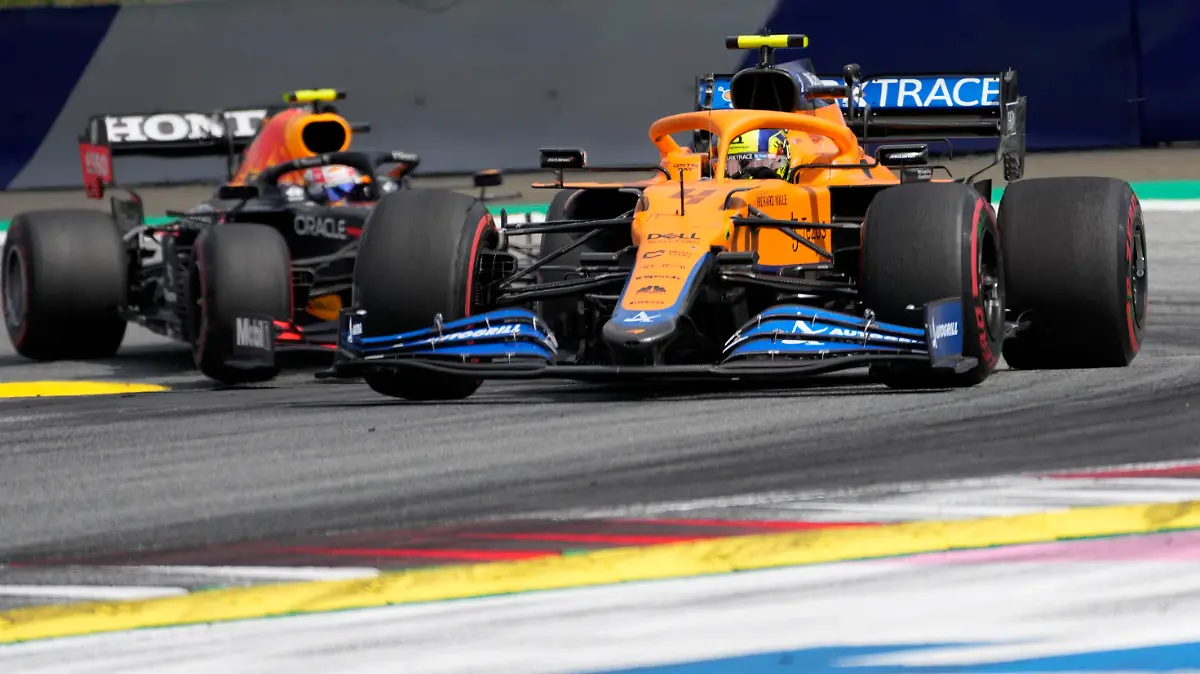 Mclaren driver Lando Norris of Britain leads ahead of Red Bull driver Sergio Perez of Mexiconduring the Styrian Formula One Grand Prix at the Red Bull Ring racetrack in Spielberg, Austria, Sunday, June 27, 2021. (AP Photo/Darko Vojinovic)
